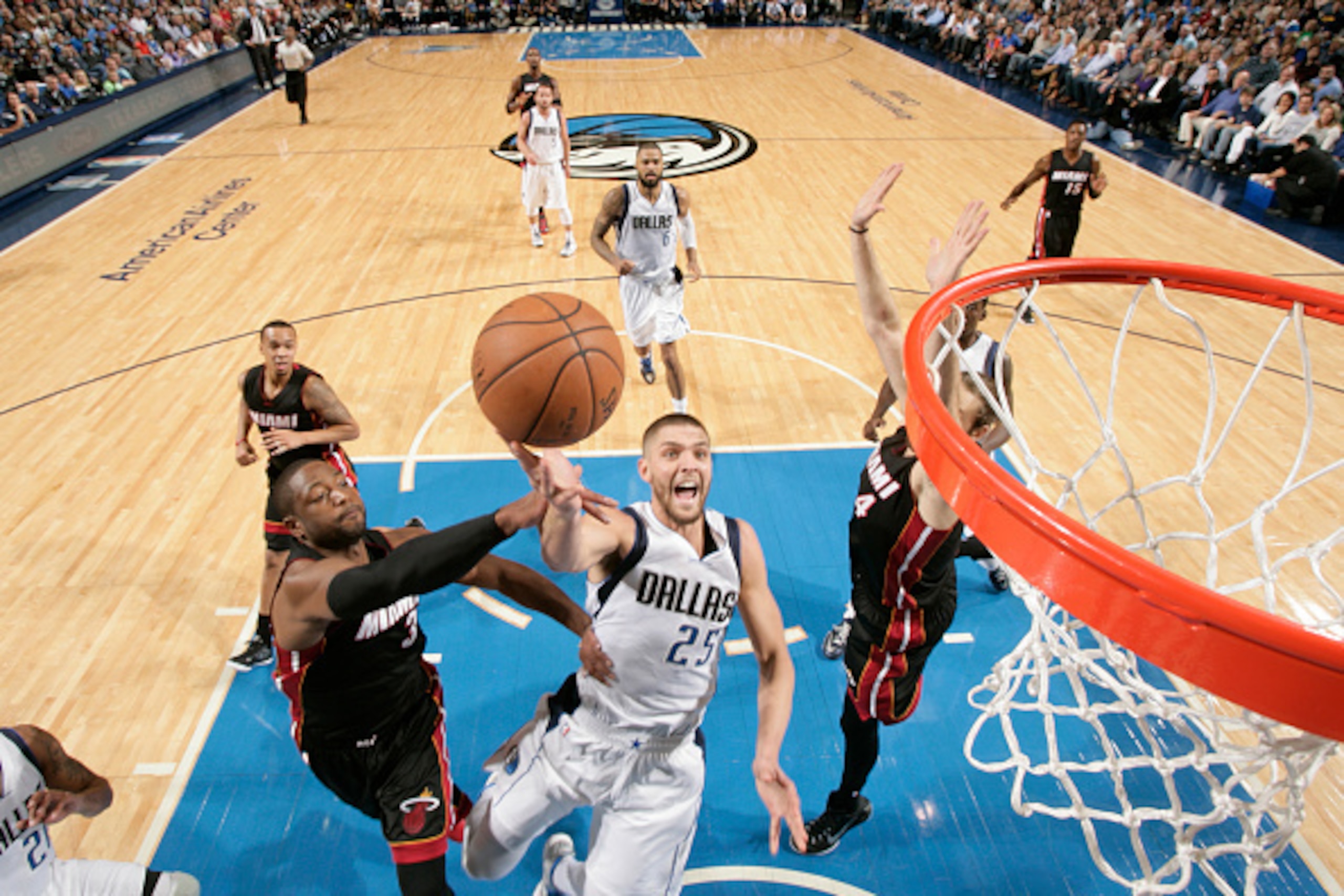 DALLAS, TX - NOVEMBER 9: Chandler Parsons #25 of the Dallas Mavericks goes in for the lay up against Dwyane Wade #3 of the Miami Heat on November 9, 2014 at the American Airlines Center in Dallas, Texas. NOTE TO USER: User expressly acknowledges and agree