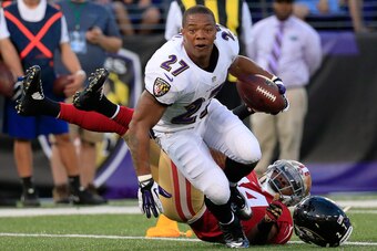BALTIMORE, MD - AUGUST 07:  Running back Ray Rice #27 of the Baltimore Ravens looses his helmet after being tackled by strong safety Antoine Bethea #24 of the San Francisco 49ers during the first half of an NFL pre-season game at M&T Bank Stadium on Augus