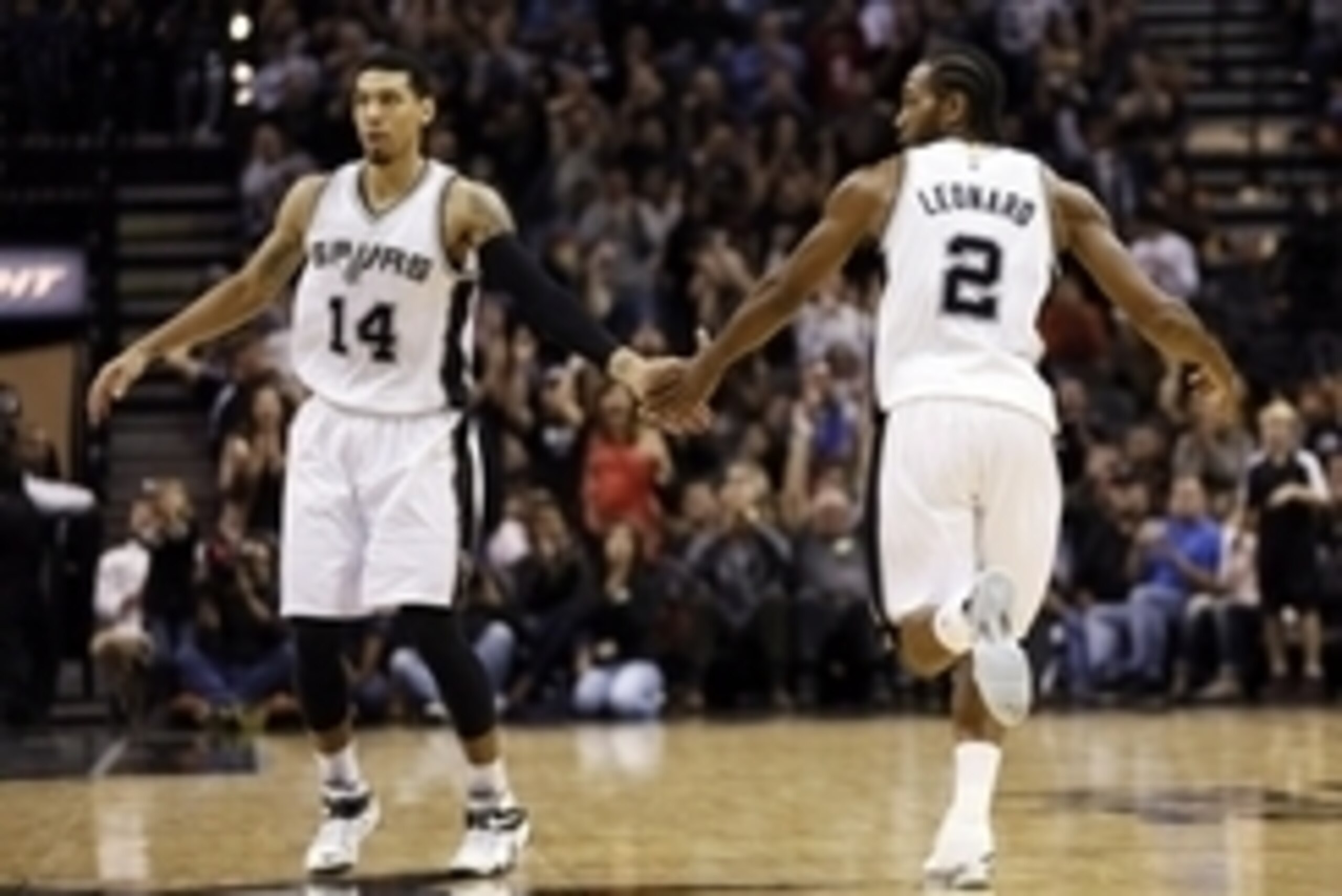 Nov 26, 2014; San Antonio, TX, USA; San Antonio Spurs small forward Kawhi Leonard (2) celebrates with shooting guard Danny Green (14) after scoring during the second half against the Indiana Pacers at AT&T Center. The Spurs won 106-100. Mandatory Credit: 