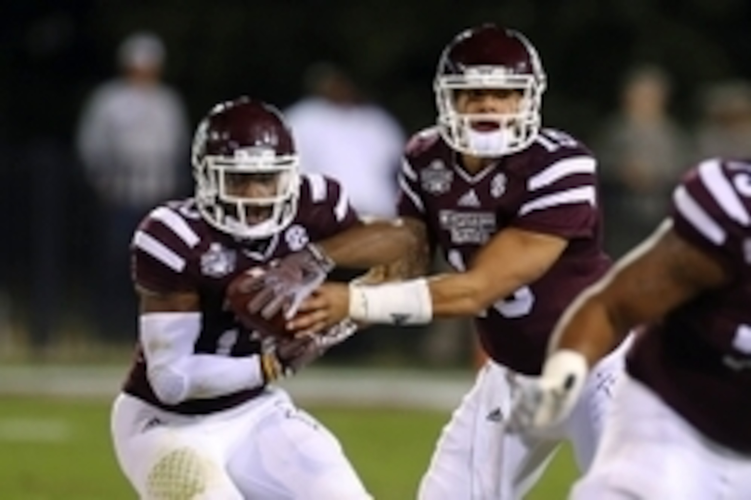 Nov 22, 2014; Starkville, MS, USA; Mississippi State Bulldogs quarterback Dak Prescott (15) hands the ball off to running back Josh Robinson (13) during the game against Vanderbilt at Davis Wade Stadium. Mandatory Credit: Spruce Derden-USA TODAY Sports