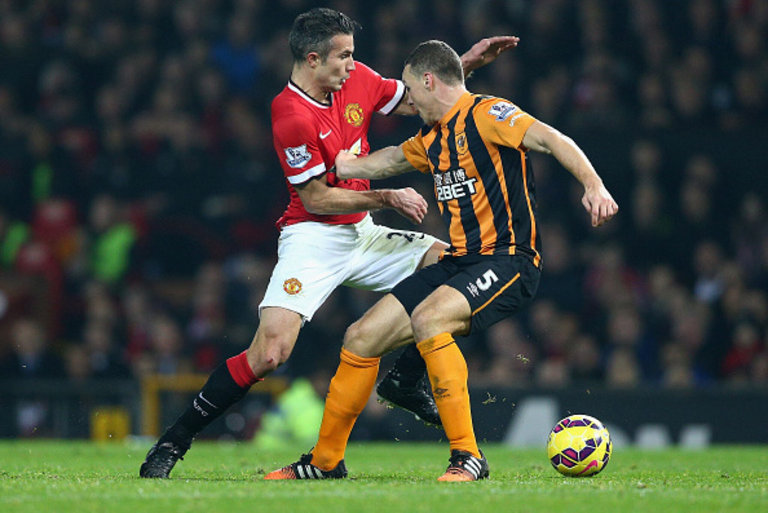 MANCHESTER, ENGLAND - NOVEMBER 29:  Robin van Persie of Manchester United and James Chester of Hull City battle for the ball during the Barclays Premier League match between Manchester United and Hull City at Old Trafford on November 29, 2014 in Mancheste