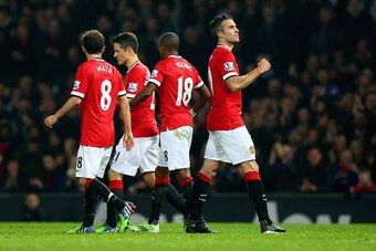 MANCHESTER, ENGLAND - NOVEMBER 29: Robin van Persie of Manchester United (R) celebrates scoring their third goal during the Barclays Premier League match between Manchester United and Hull City at Old Trafford on November 29, 2014 in Manchester, England. 