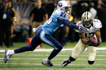 NEW ORLEANS, LA - AUGUST 15:  Joe Morgan #13 of the New Orleans Saints catches a pass as Coty Sensabaugh #24 of the Tennessee Titans defends during a preseason game between the New Orleans Saints and the Tennessee Titans at Mercedes-Benz Superdome on Augu