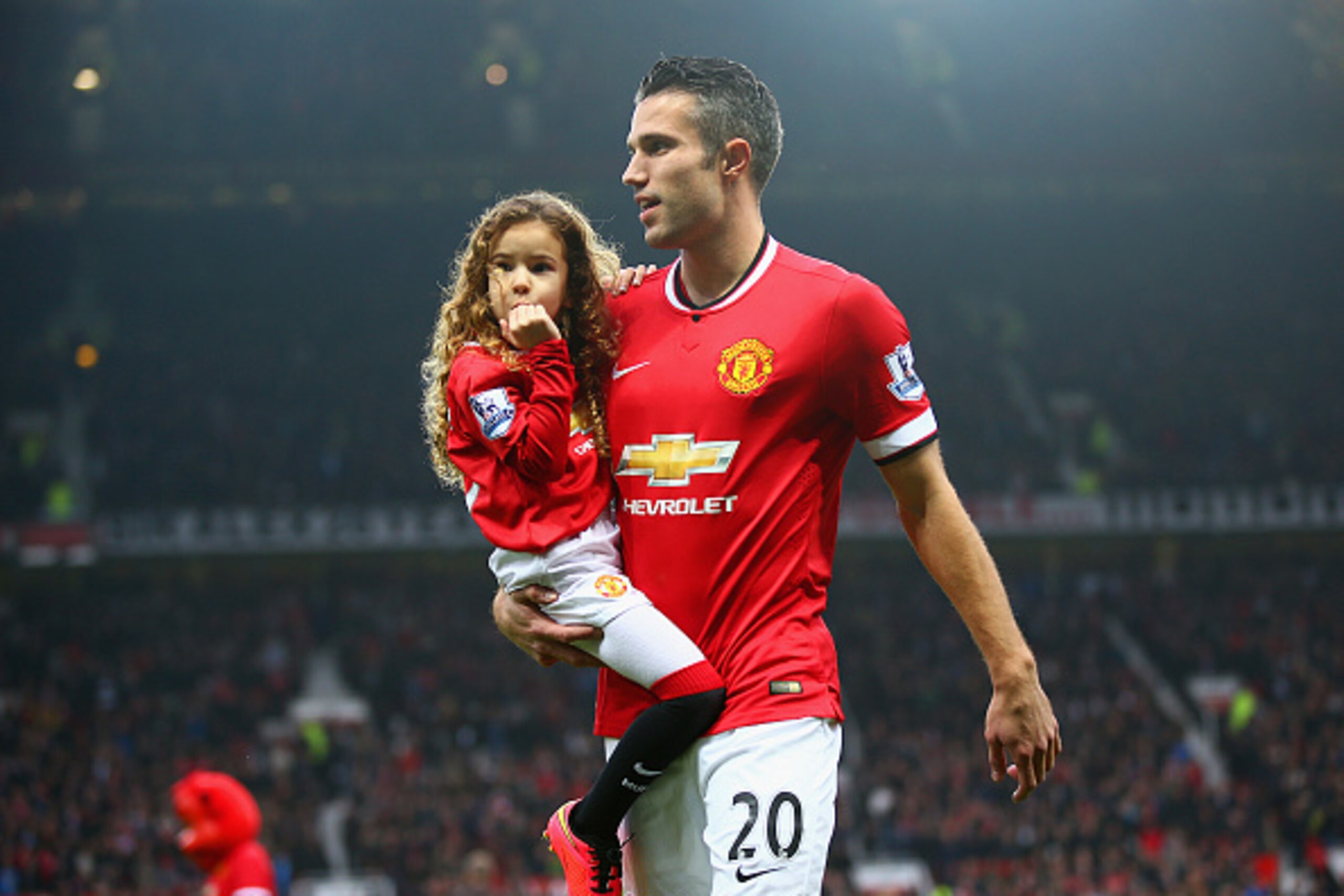 MANCHESTER, ENGLAND - NOVEMBER 29:  Robin van Persie of Manchester United walks with his daughter Dina Layla Van Persie uring the Barclays Premier League match between Manchester United and Hull City at Old Trafford on November 29, 2014 in Manchester, Eng