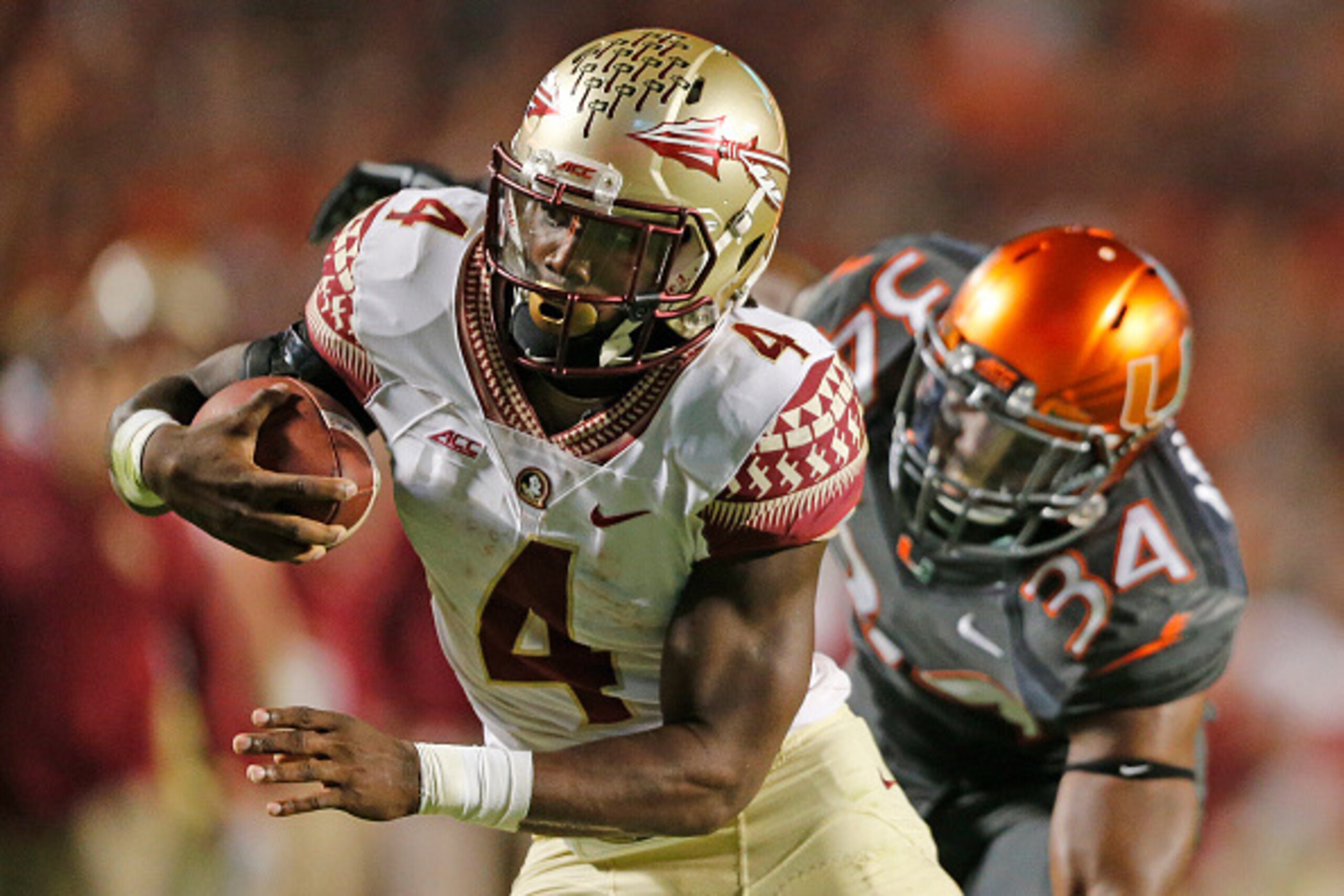 MIAMI GARDENS, FL - NOVEMBER 15: Dalvin Cook #4 of the Florida State Seminoles scores the winning touchdown in the fourth quarter against the Miami Hurricanes on November 15, 2014 at Sun Life Stadium in Miami Gardens, Florida. The Seminoles defeated the H