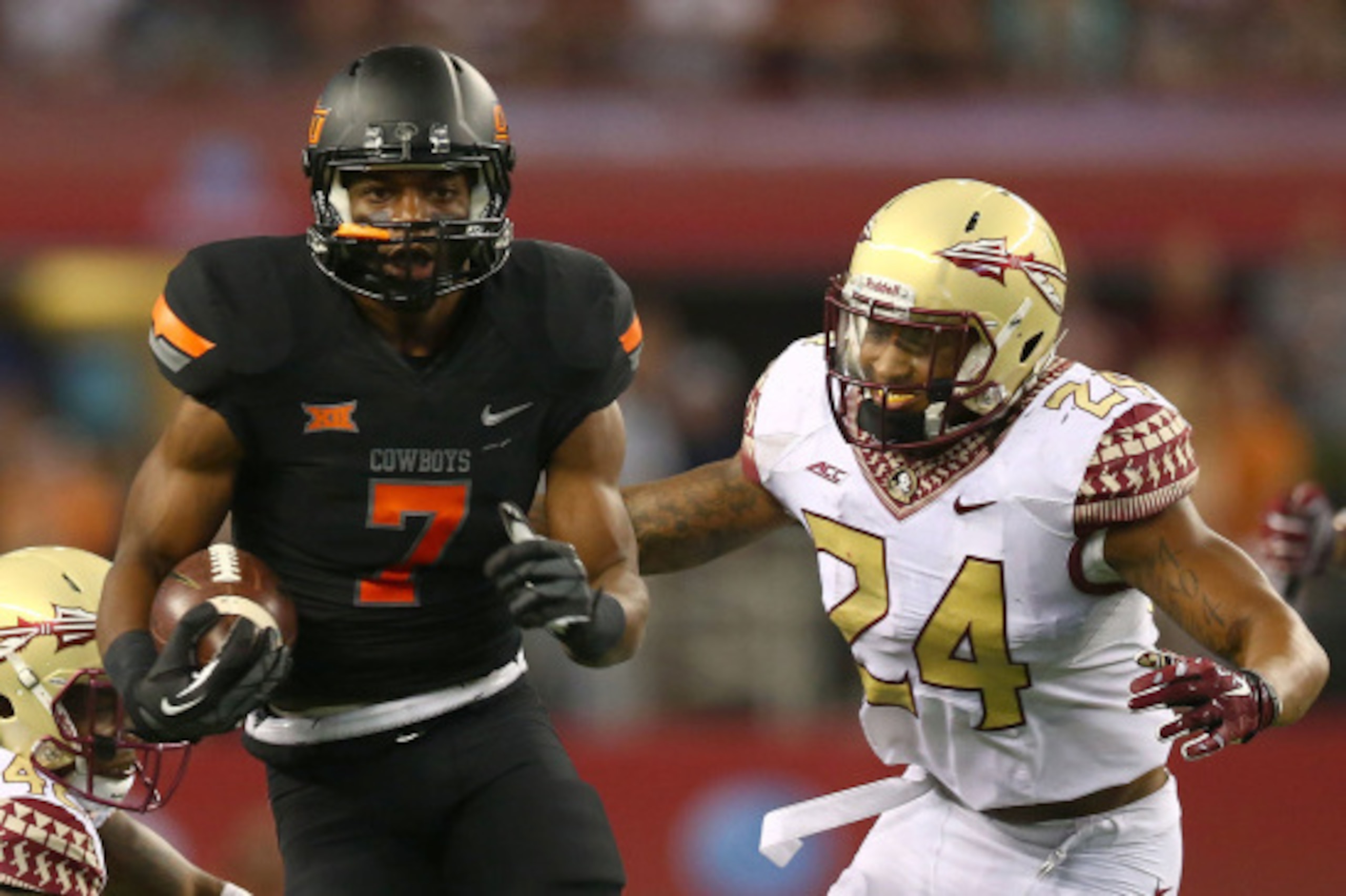 ARLINGTON, TX - AUGUST 30:  Brandon Sheperd #7 of the Oklahoma State Cowboys carries the ball as Terrance Smith #24 of the Florida State Seminoles gives chase in the second half of the Advocare Cowboys Classic at AT&T Stadium on August 30, 2014 in Arlingt