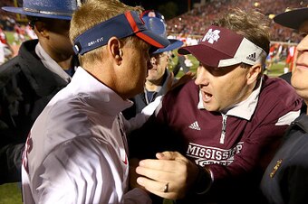 OXFORD, MS - NOVEMBER 29:  (L-R) Head coach Hugh Freeze of the Mississippi Rebels shakes hands with head coach Dan Mullen of the Mississippi State Bulldogs after the Rebels defeated the Bulldogs 31-17 at Vaught-Hemingway Stadium on November 29, 2014 in Ox