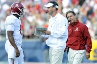Oct 4, 2014; Oxford, MS, USA; Alabama Crimson offensive coordinator Lane Kiffin talks with quarterback Blake Sims (6) as head coach Nick Saban looks on during the second half against Mississippi Rebels at Vaught-Hemingway Stadium. Mandatory Credit: Christ