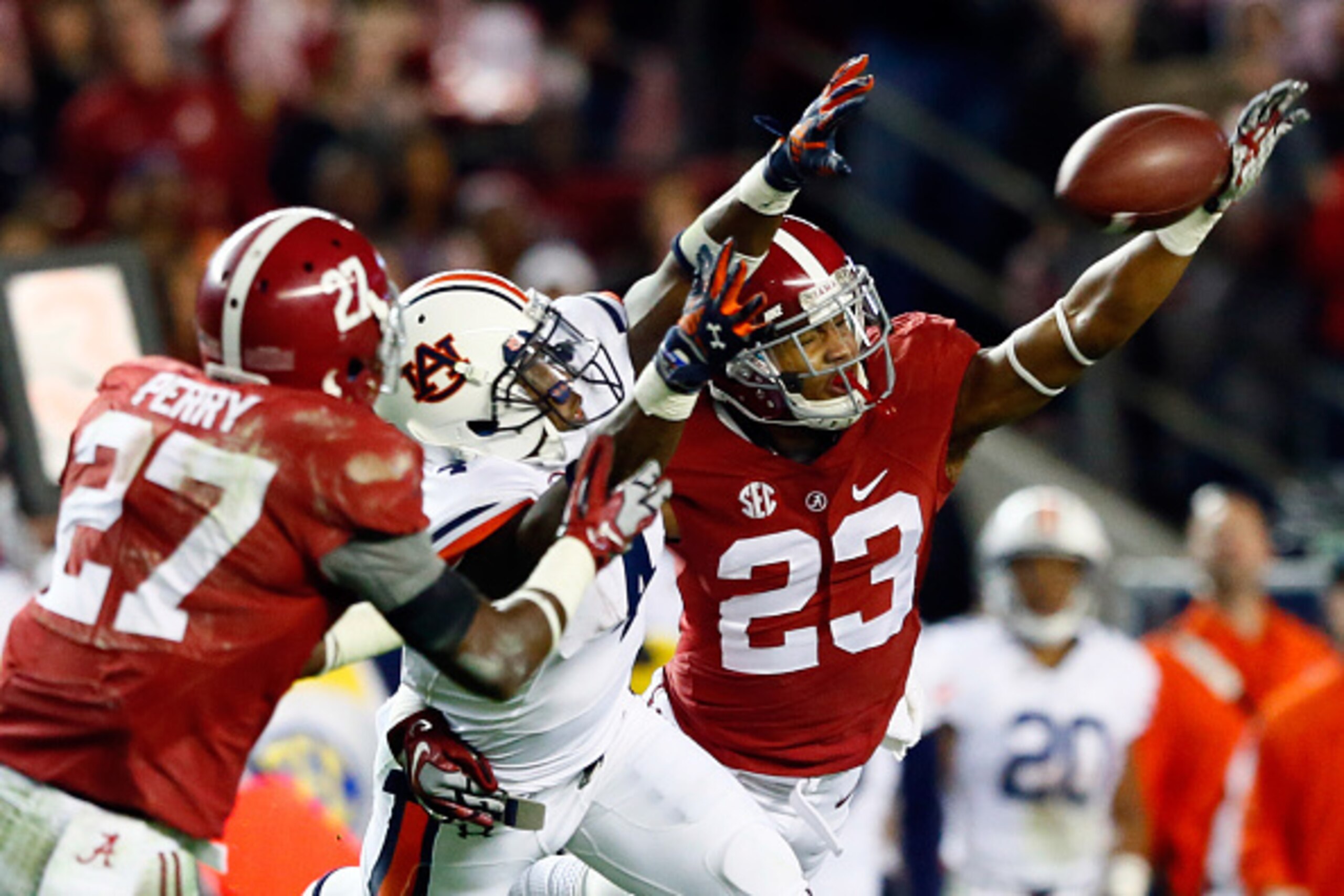 TUSCALOOSA, AL - NOVEMBER 29:  Nick Perry #27 of the Alabama Crimson Tide intercepts a pass intended for Quan Bray #4 of the Auburn Tigers thrown by Nick Marshall #14 in the fourth quarter during the Iron Bowl at Bryant-Denny Stadium on November 29, 2014 