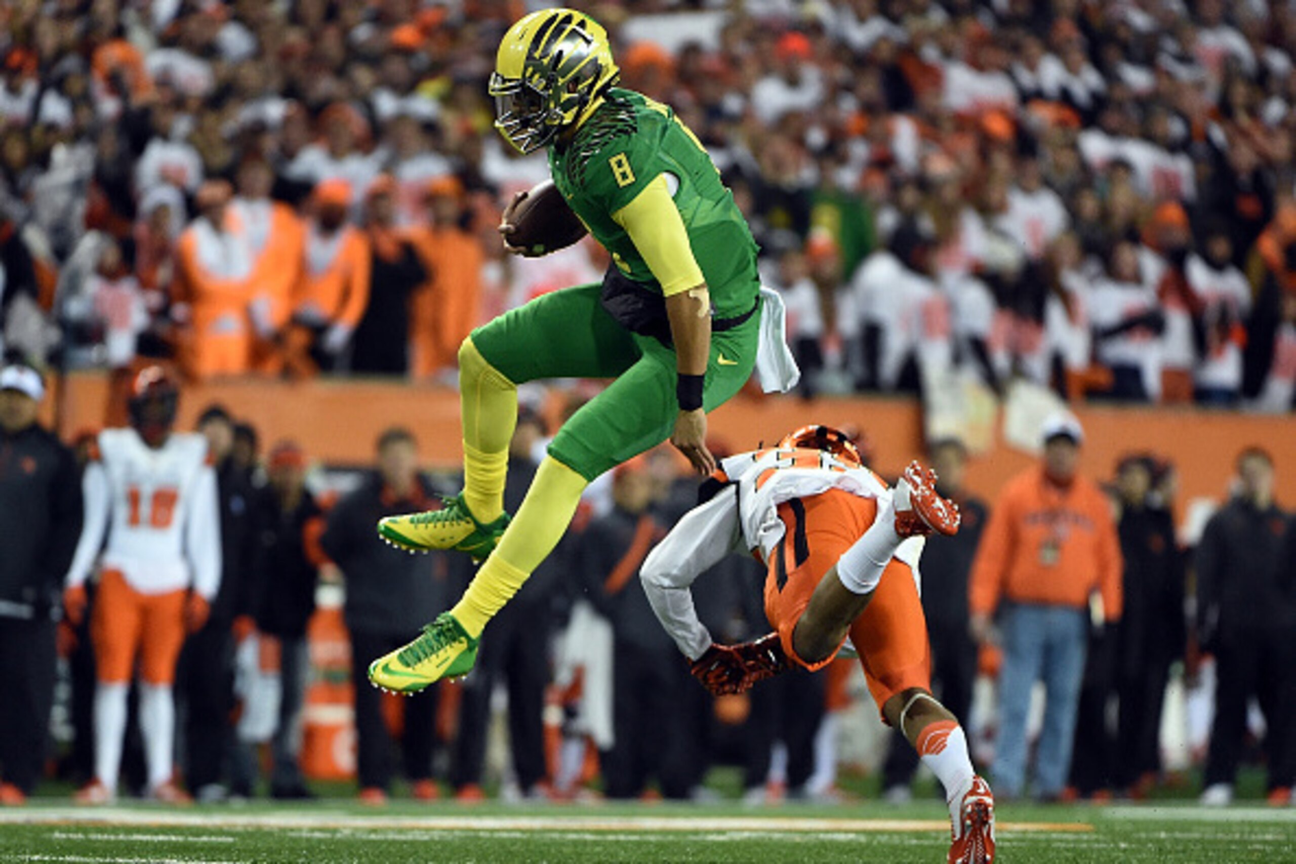 CORVALLIS, OR - NOVEMBER 29: Quarterback Marcus Mariota #8 of the Oregon Ducks hurdles safety Justin Strong #39 of the Oregon State Beavers during the first quarter of the game at Reser Stadium on November 29, 2014 in Corvallis, Oregon. (Photo by Steve CORVALLIS, OR - NOVEMBER 29: Quarterback Marcus Mariota #8 of the Oregon Ducks hurdles safety Justin Strong #39 of the Oregon State Beavers during the first quarter of the game at Reser Stadium on November 29, 2014 in Corvallis, Oregon. (Photo by Steve