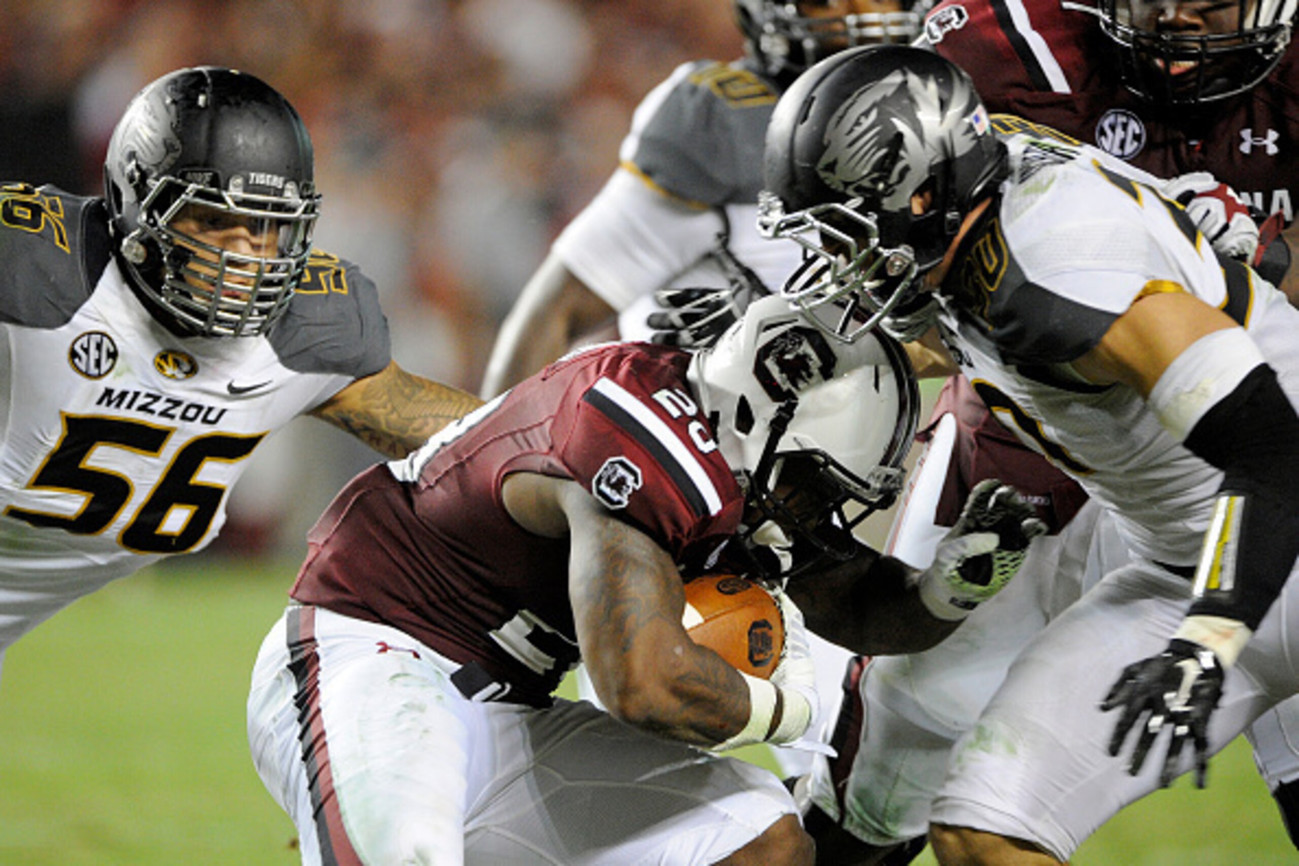 COLUMBIA, SC - SEPTEMBER 27:   Tailback Mike Davis #28 of the South Carolina Gamecocks is brought down by defensive lineman Shane Ray #56 of the Missouri Tigers and linebacker Michael Sherer #30 during the fourth quarter on September 27, 2014 at Williams-