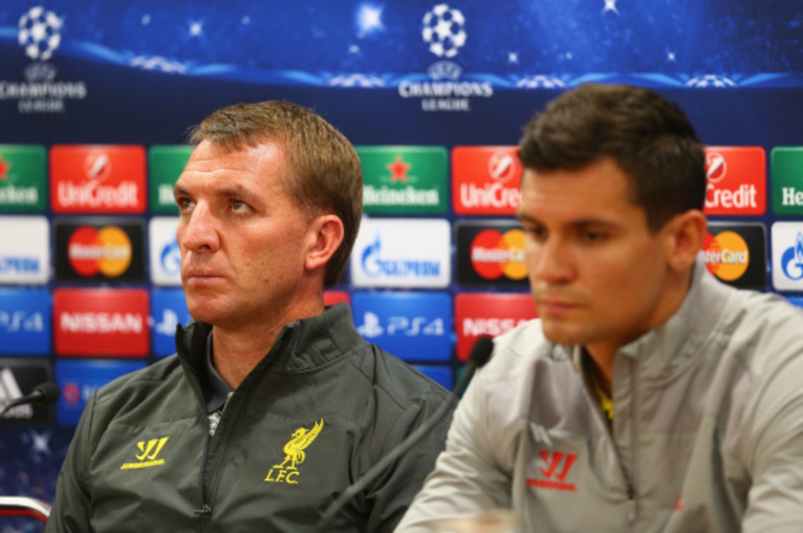 LIVERPOOL, ENGLAND - SEPTEMBER 15: Liverpool manager Brendan Rodgers deep in thought as he talks to the media whilst sitting next to his defender Dejan Lovren during a press conference ahead of their UEFA Champions League group B match against PFC Ludogo LIVERPOOL, ENGLAND - SEPTEMBER 15: Liverpool manager Brendan Rodgers deep in thought as he talks to the media whilst sitting next to his defender Dejan Lovren during a press conference ahead of their UEFA Champions League group B match against PFC Ludogo
