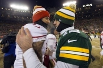 Jan 5, 2014; Green Bay, WI, USA; San Francisco 49ers quarterback Colin Kaepernick (7) greets Green Bay Packers quarterback Aaron Rodgers (12) following the 2013 NFC wild card playoff football game at Lambeau Field.  San Francisco won 23-20.  Mandatory Cre