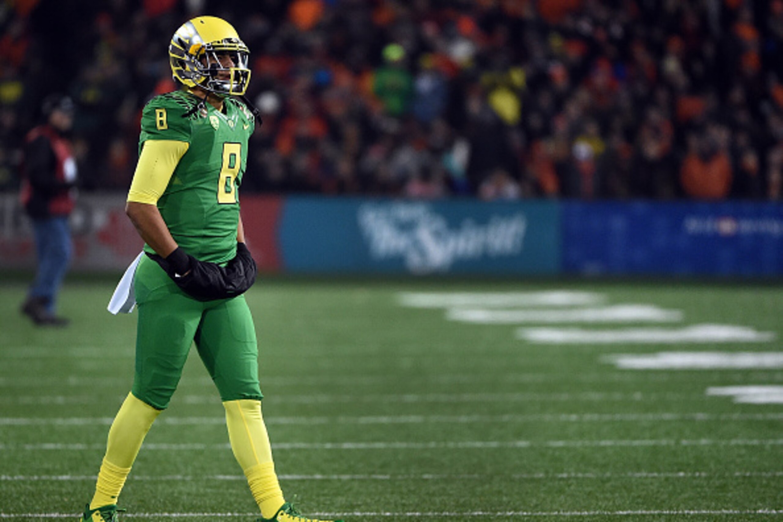 CORVALLIS, OR - NOVEMBER 29:  Quarterback Marcus Mariota #8 of the Oregon Ducks walks out on the field to greet his teammates as they come off the field during the second quarter of the game against the Oregon State Beavers at Reser Stadium on November 29
