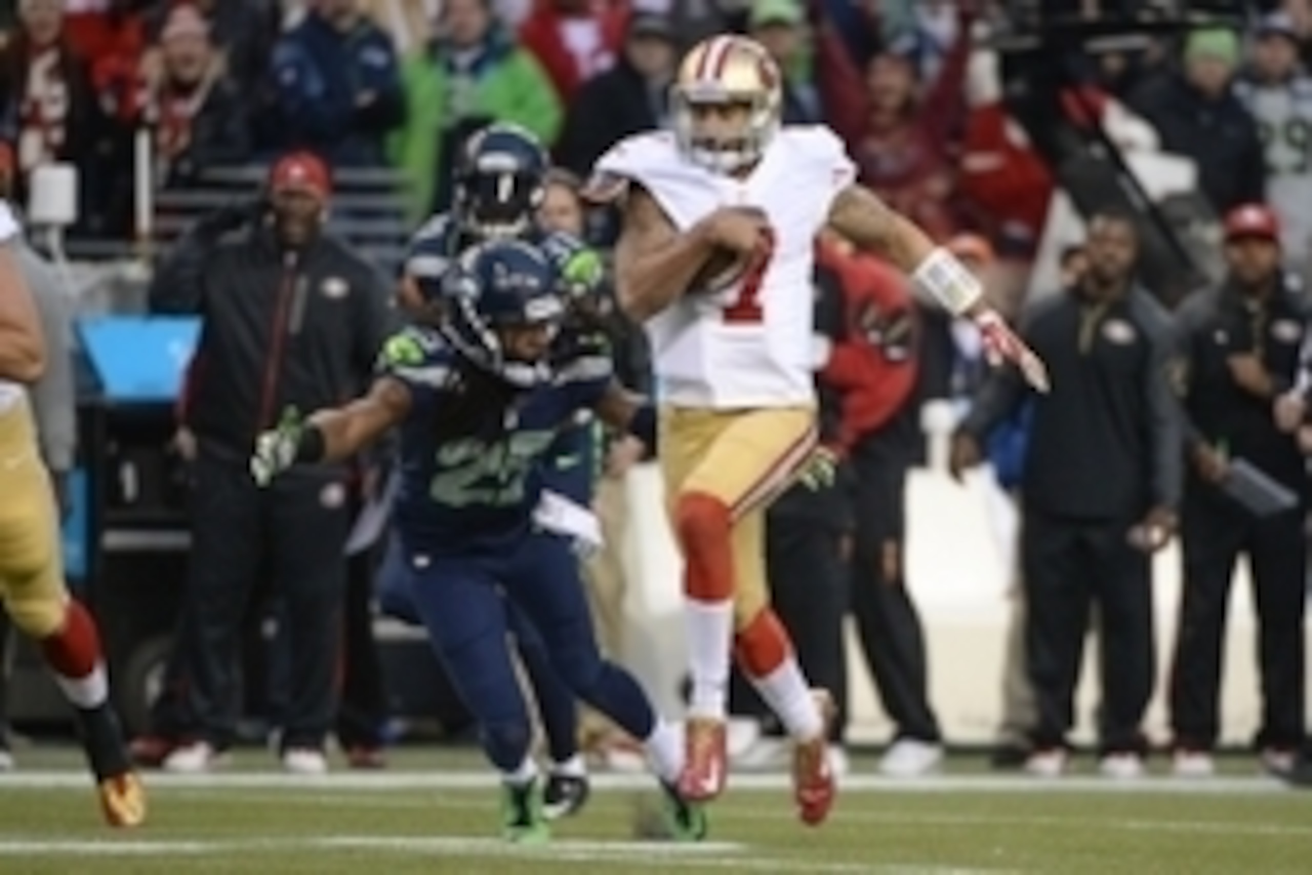 Jan 19, 2014; Seattle, WA, USA; San Francisco 49ers quarterback Colin Kaepernick (7) runs the football against Seattle Seahawks cornerback Richard Sherman (25) during the first half of the 2013 NFC Championship football game at CenturyLink Field. The Seah Jan 19, 2014; Seattle, WA, USA; San Francisco 49ers quarterback Colin Kaepernick (7) runs the football against Seattle Seahawks cornerback Richard Sherman (25) during the first half of the 2013 NFC Championship football game at CenturyLink Field. The Seah