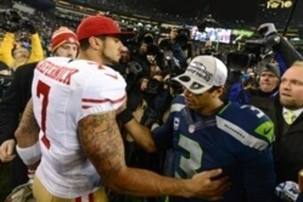 Jan 19, 2014; Seattle, WA, USA; San Francisco 49ers quarterback Colin Kaepernick (7) congratulates Seattle Seahawks quarterback Russell Wilson (3) after the 2013 NFC Championship football game at CenturyLink Field. The Seahawks defeated the 49ers 23-17. M