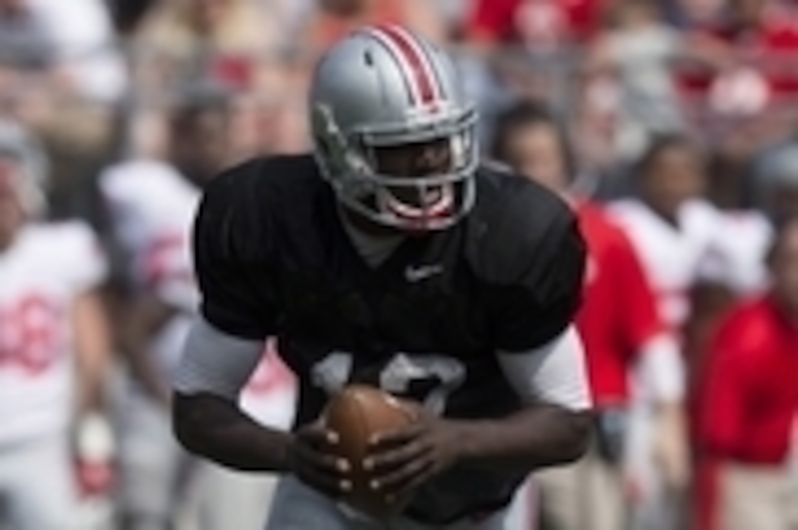 Apr 12, 2014; Columbus, OH, USA; Ohio State scarlet team quarterback Cardale Jones (12) runs around the outside during the Ohio State Buckeyes spring game at Ohio Stadium. The scarlet team won the game 17-7. Mandatory Credit: Greg Bartram-USA TODAY Sports