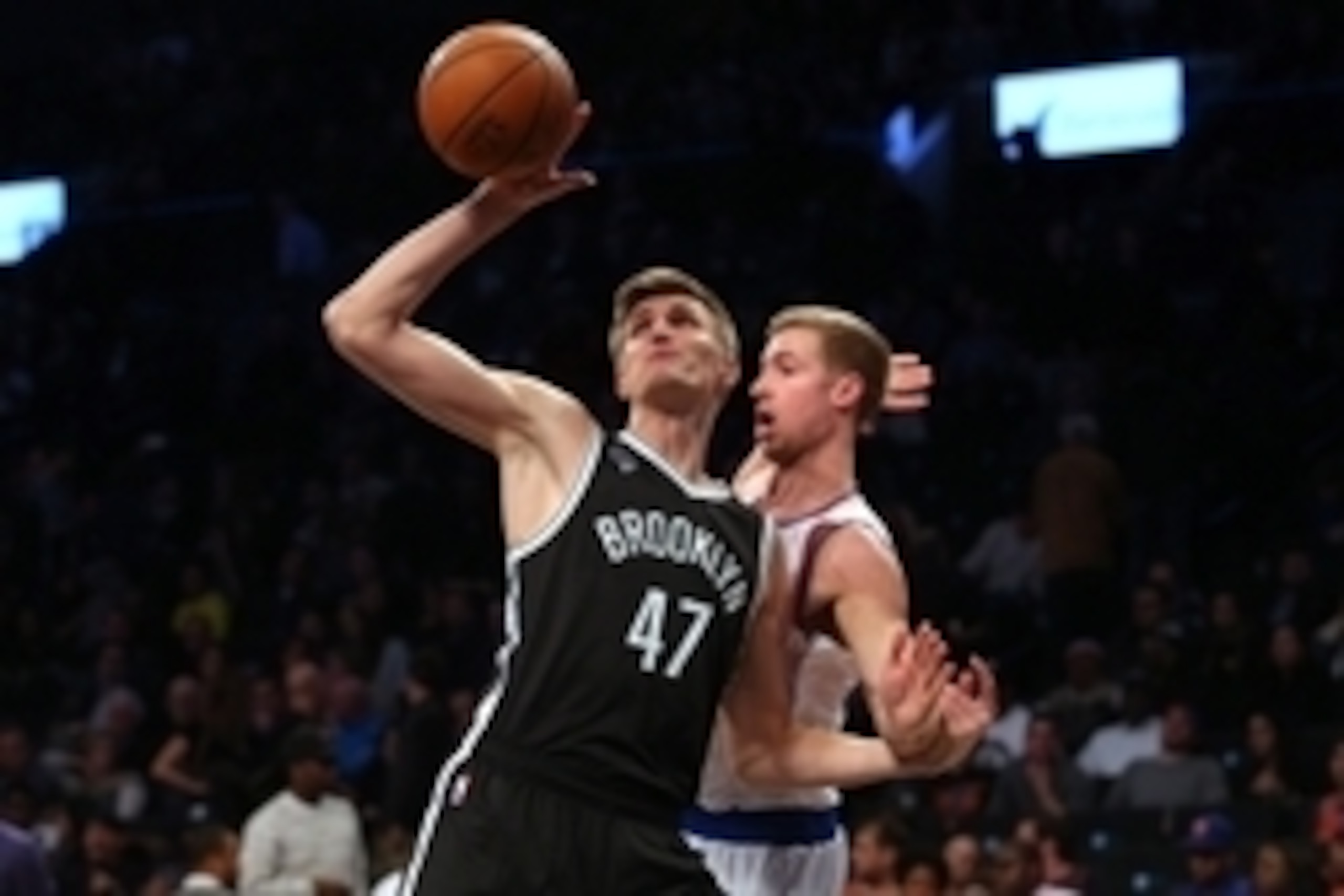 Nov 7, 2014; Brooklyn, NY, USA; Brooklyn Nets small forward Andrei Kirilenko (47) grabs a rebound in front of New York Knicks small forward Travis Wear (6) during the fourth quarter at Barclays Center. The Nets defeated the Knicks 110-99. Mandatory Credit