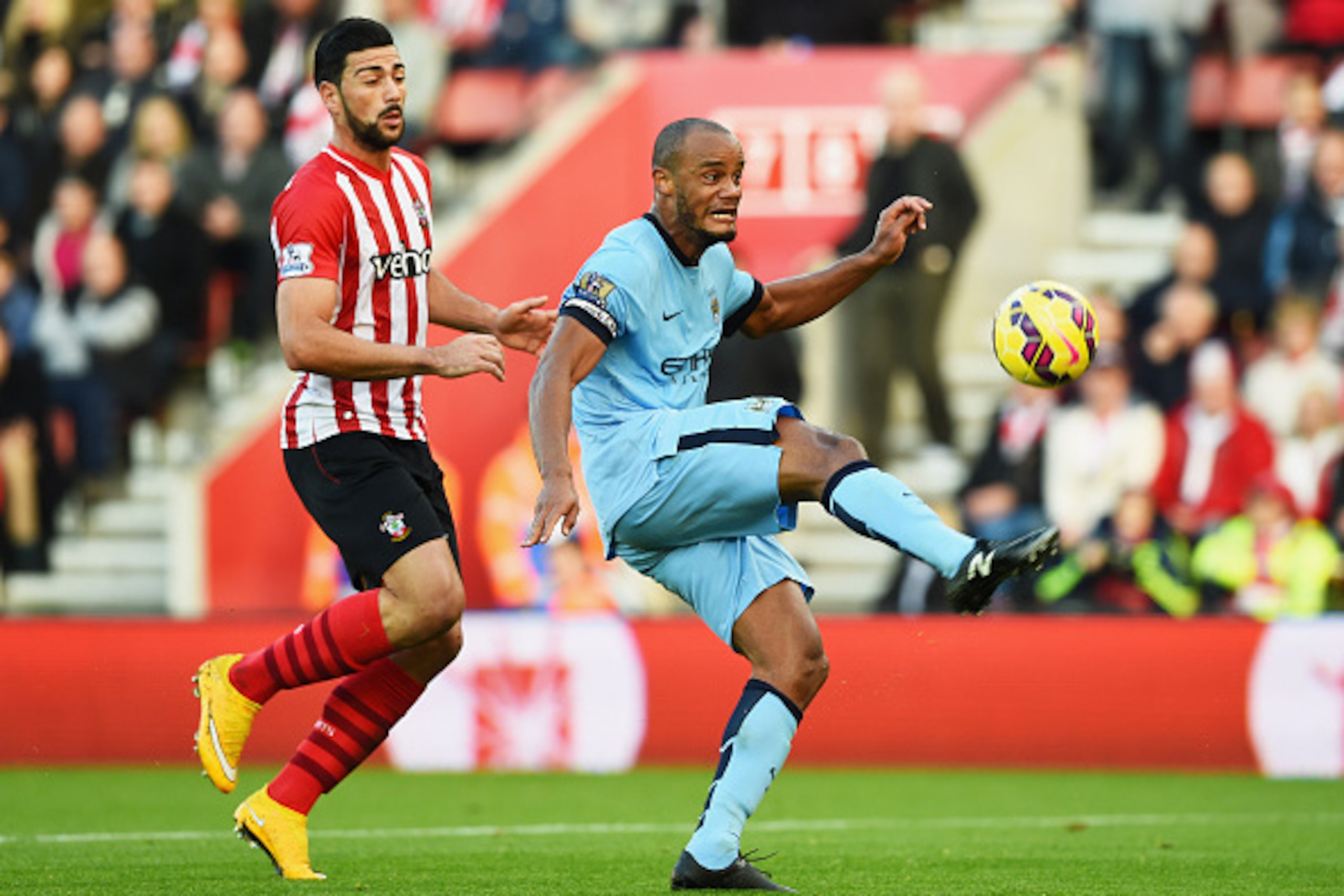 SOUTHAMPTON, ENGLAND - NOVEMBER 30:  Vincent Kompany of Manchester City clears the ball from Graziano Pelle of Southampton during the Barclays Premier League match between Southampton and Manchester City at St Mary's Stadium on November 30, 2014 in Southa