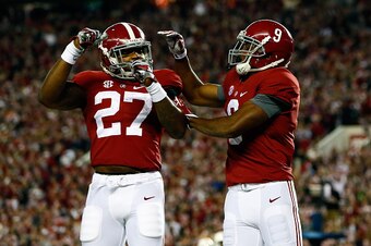TUSCALOOSA, AL - NOVEMBER 29:  Amari Cooper #9 of the Alabama Crimson Tide celebrates with Derrick Henry #27 after catching a 39 yard touchdown pass thrown by Blake Sims #6 in the third quarter against the Auburn Tigers during the Iron Bowl at Bryant-Denn
