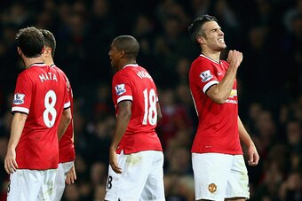 MANCHESTER, ENGLAND - NOVEMBER 29:  Robin van Persie of Manchester United (R) celebrates scoring their third goal with team mates during the Barclays Premier League match between Manchester United and Hull City at Old Trafford on November 29, 2014 in Manc