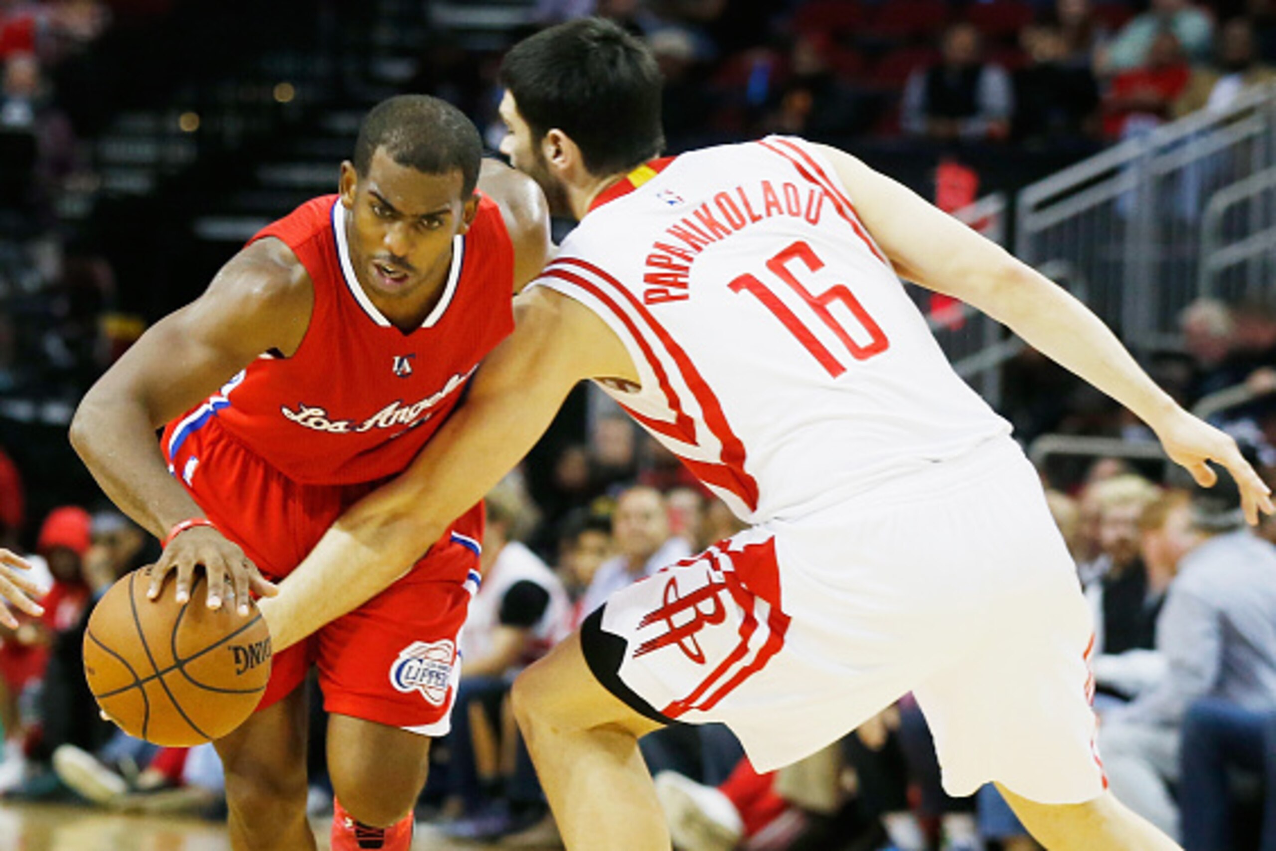 HOUSTON, TX - NOVEMBER 28:  Chris Paul #3 of the Los Angeles Clippers dribbles the basketball past Kostas Papanikolaou #16 of the Houston Rockets  during their game at the Toyota Center on November 28, 2014 in Houston, Texas.  NOTE TO USER: User expressly