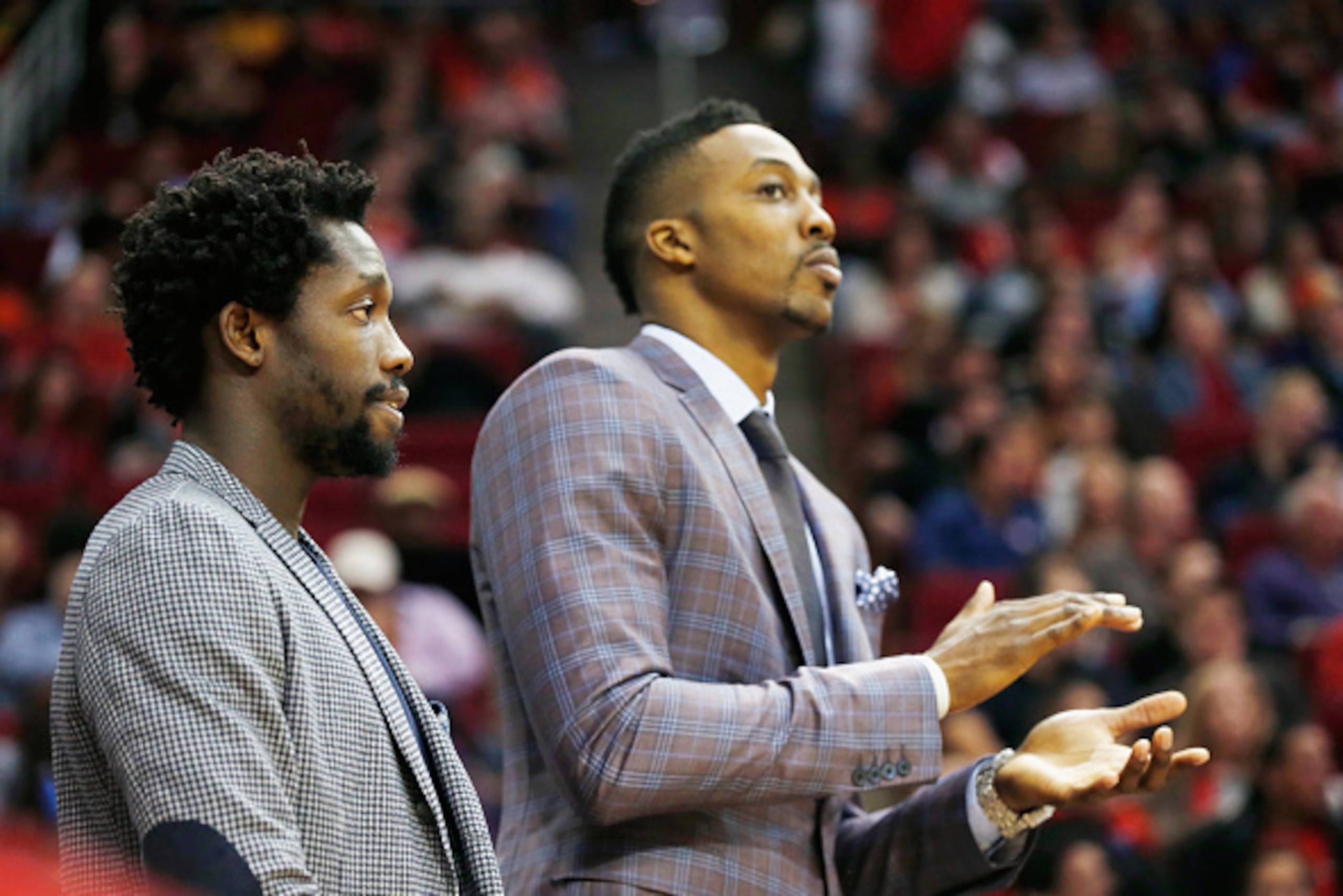 HOUSTON, TX - NOVEMBER 26:  Patrick Beverley #2 and Dwight Howard #12 of the Houston Rockets wait near the bench during their game against the Sacramento Kings at the Toyota Center on November 26, 2014 in Houston, Texas.  NOTE TO USER: User expressly ackn