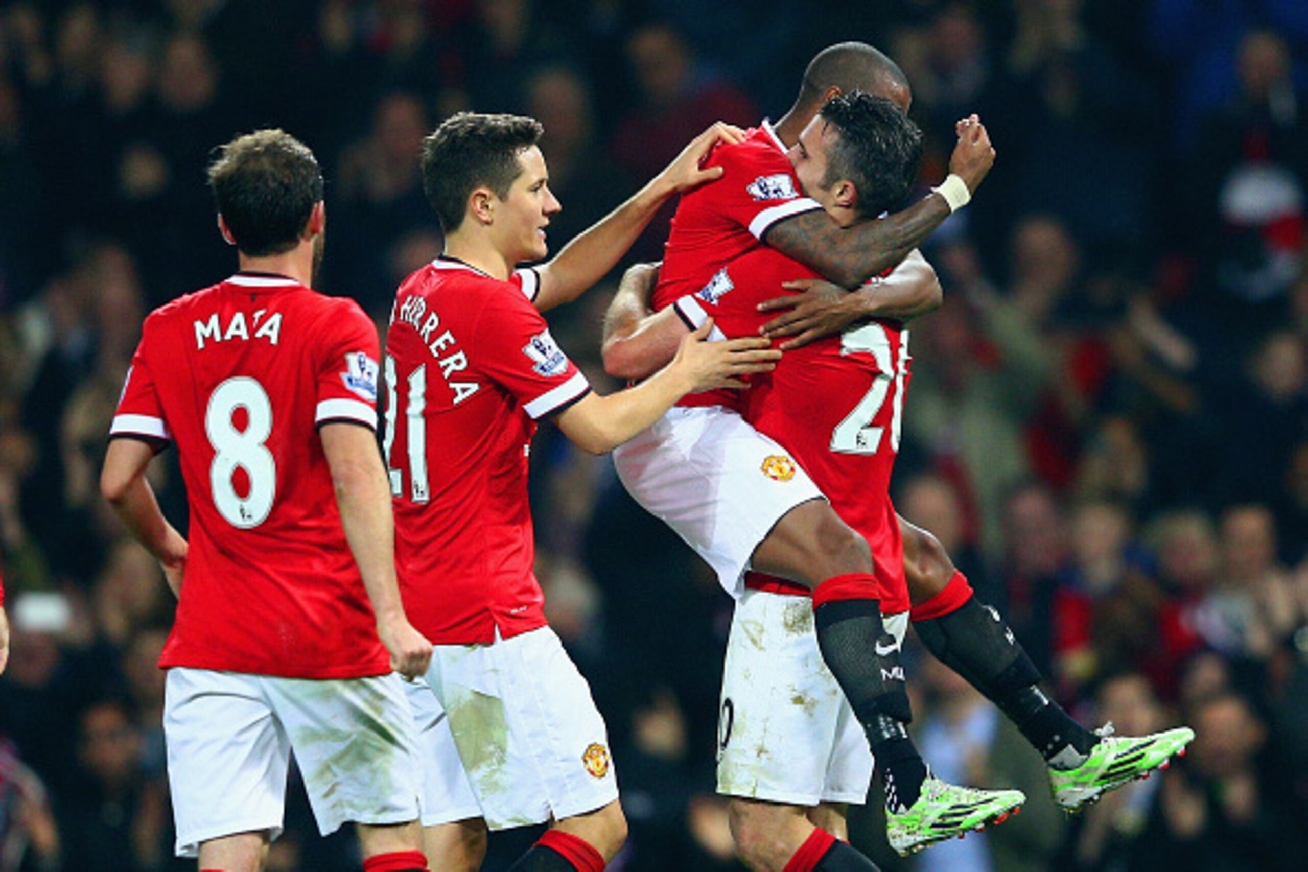 MANCHESTER, ENGLAND - NOVEMBER 29:  Robin van Persie of Manchester United (R) celebrates scoring their third goal with team mates during the Barclays Premier League match between Manchester United and Hull City at Old Trafford on November 29, 2014 in Manc