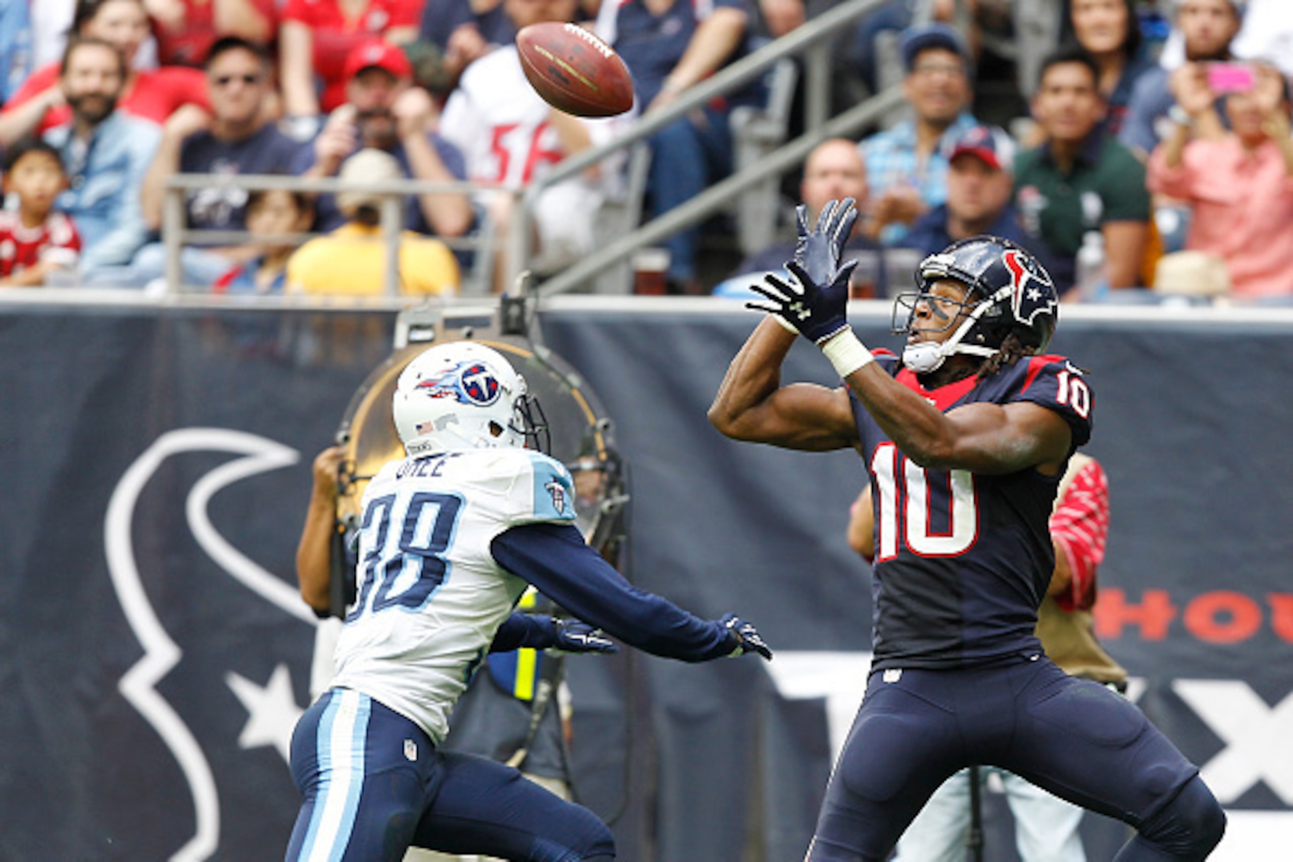 HOUSTON, TX - NOVEMBER 30: DeAndre Hopkins #10 of the Houston Texans makes a touchdown catch against Brandon Ghee #38 of the Tennessee Titans in the third quarter in a NFL game on November 30, 2014 at NRG Stadium in Houston, Texas. (Photo by Bob Levey/Get HOUSTON, TX - NOVEMBER 30: DeAndre Hopkins #10 of the Houston Texans makes a touchdown catch against Brandon Ghee #38 of the Tennessee Titans in the third quarter in a NFL game on November 30, 2014 at NRG Stadium in Houston, Texas. (Photo by Bob Levey/Get