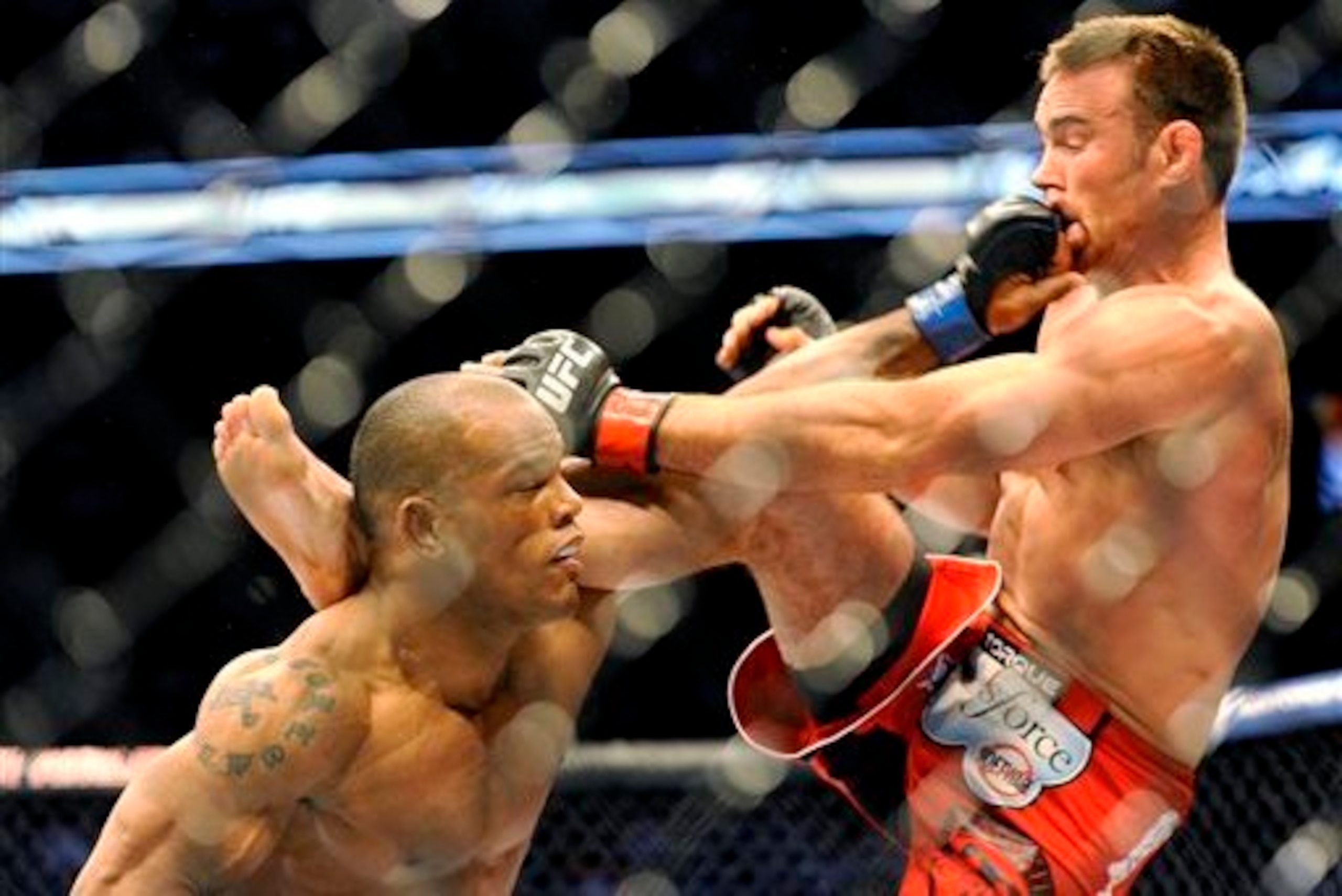 Hector Lombard throws a left at Jake Shields in their bout at UFC 171.