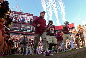 TALLAHASSEE, FL - NOVEMBER 29: Head coach Jimbo Fisher of the Florida State Seminoles leads the team onto the field during a game against the Florida Gators   at Doak Campbell Stadium on November 29, 2014 in Tallahassee, Florida.  (Photo by Mike Ehrmann/G
