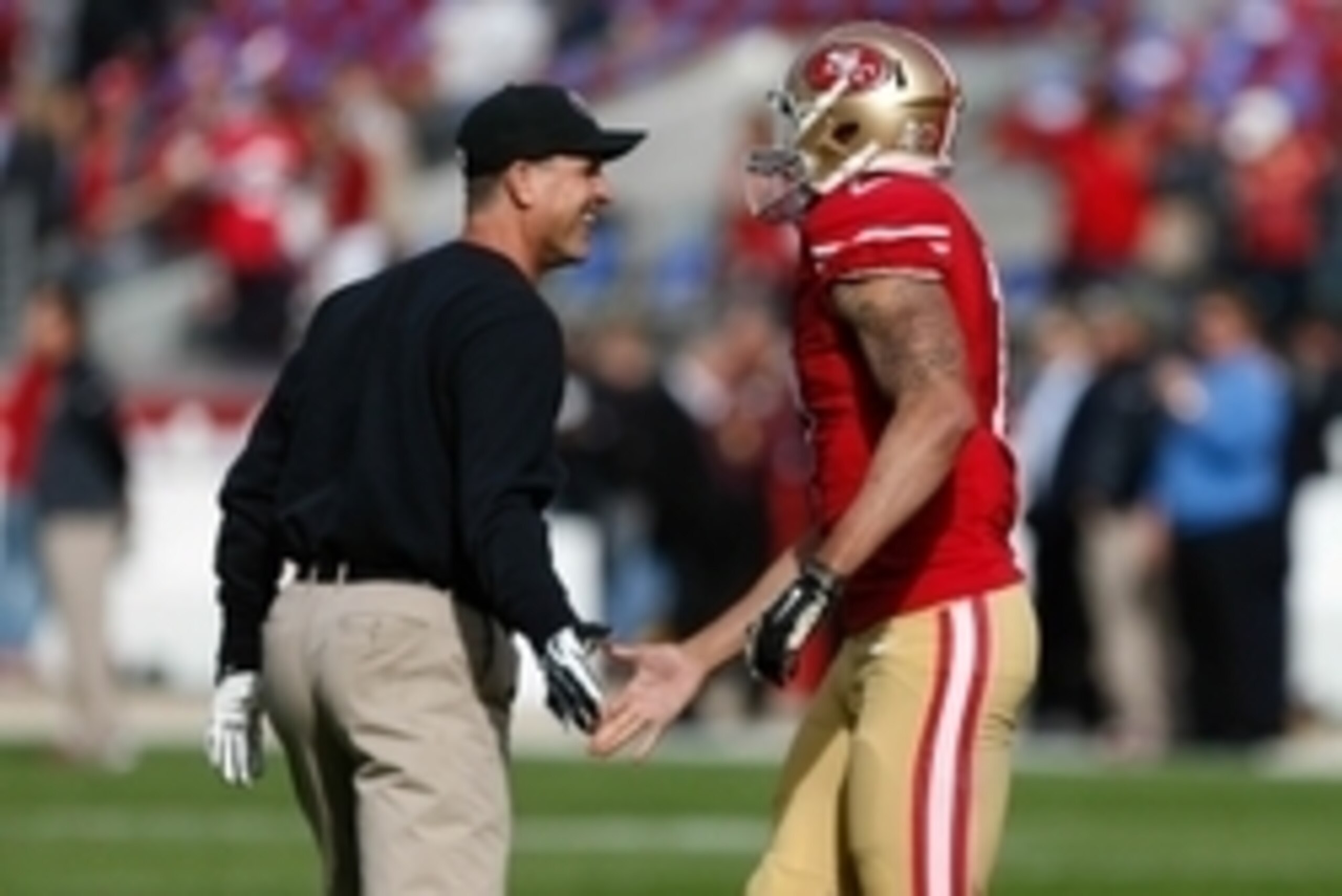 Nov 23, 2014; Santa Clara, CA, USA; San Francisco 49ers head coach Jim Harbaugh high fives quarterback Colin Kaepernick (7) before the game against the Washington Redskins at Levi's Stadium. Mandatory Credit: Kelley L Cox-USA TODAY Sports