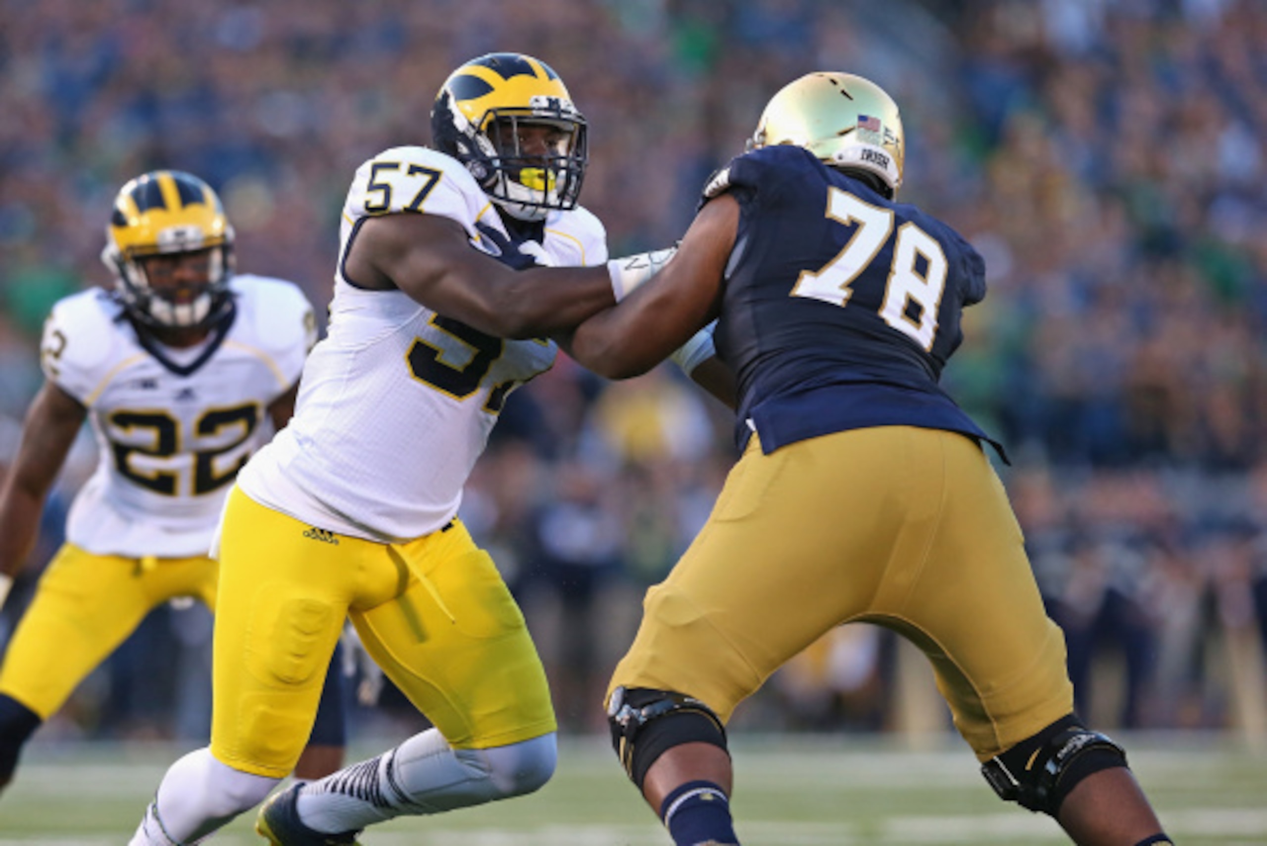 SOUTH BEND, IN - SEPTEMBER 06:  Frank Clark #57 of the Michigan Wolverines rushes against Ronnie Stanley #78 of the Notre Dame Fighting Irish at Notre Dame Stadium on September 6, 2014 in South Bend, Indiana. Notre Dame defeated Michigan 31-0.  (Photo by 