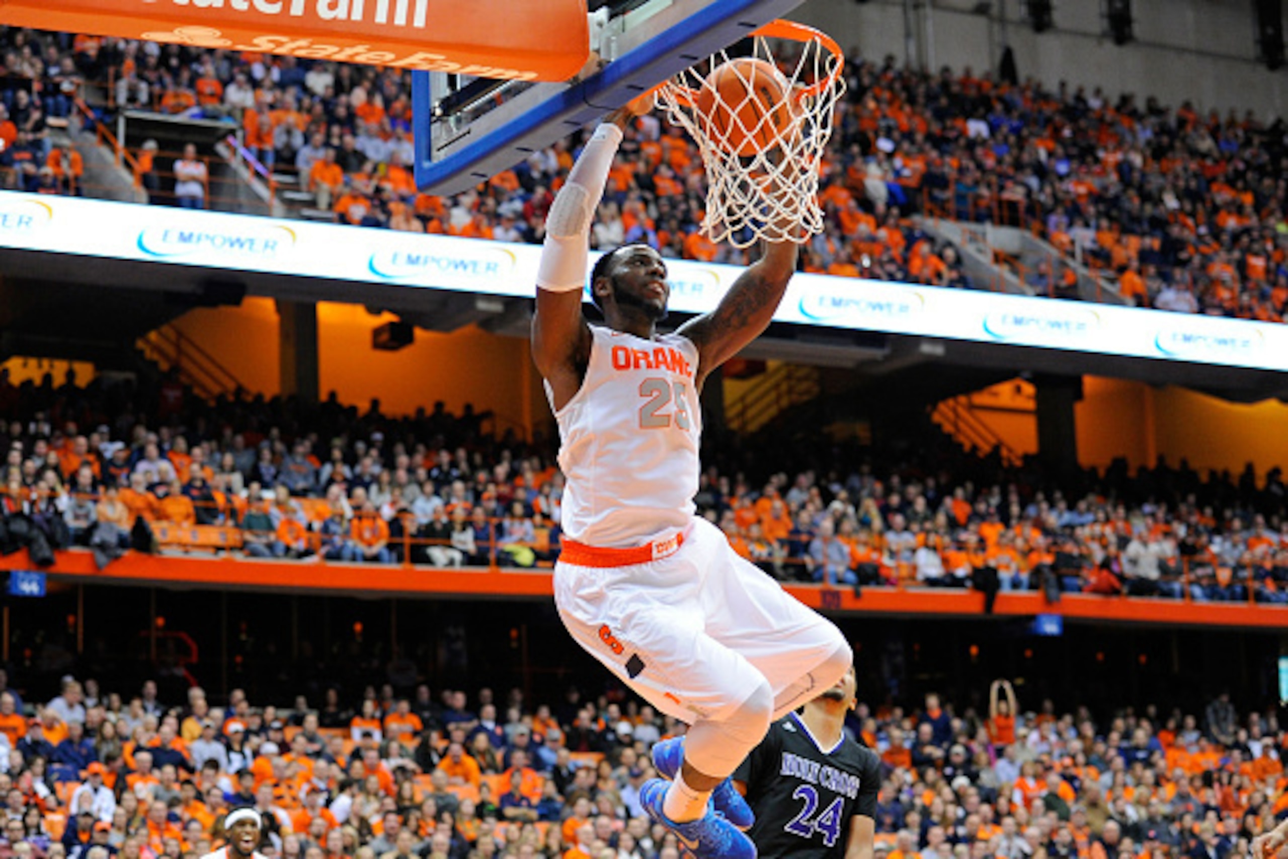SYRACUSE, NY - NOVEMBER 28:  Rakeem Christmas #25 of the Syracuse Orange dunks the ball in front of Eric Green #24 of the Holy Cross Crusaders during the second half at the Carrier Dome on November 28, 2014 in Syracuse, New York.  Syracuse defeated Holy C