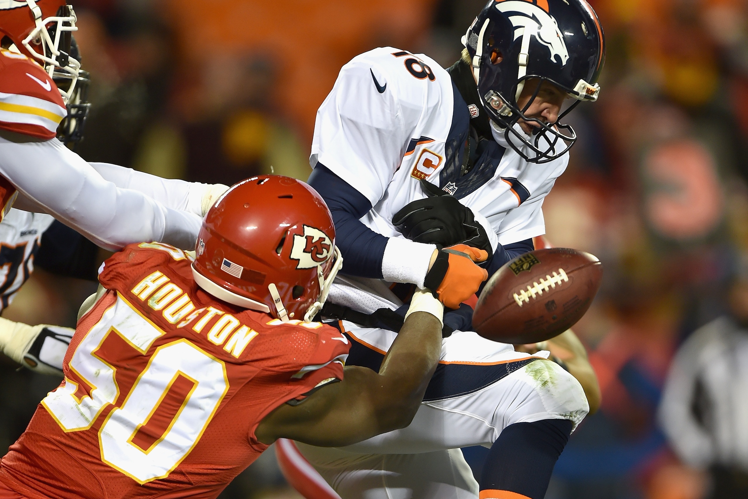 KANSAS CITY, MO - NOVEMBER 30:   Justin Houston #50 of the Kansas City Chiefs forces a fumble on  Peyton Manning #18 of the Denver Broncos during the third quarter at Arrowhead Stadium on November 30, 2014 in Kansas City, Missouri.  (Photo by Peter Aiken/