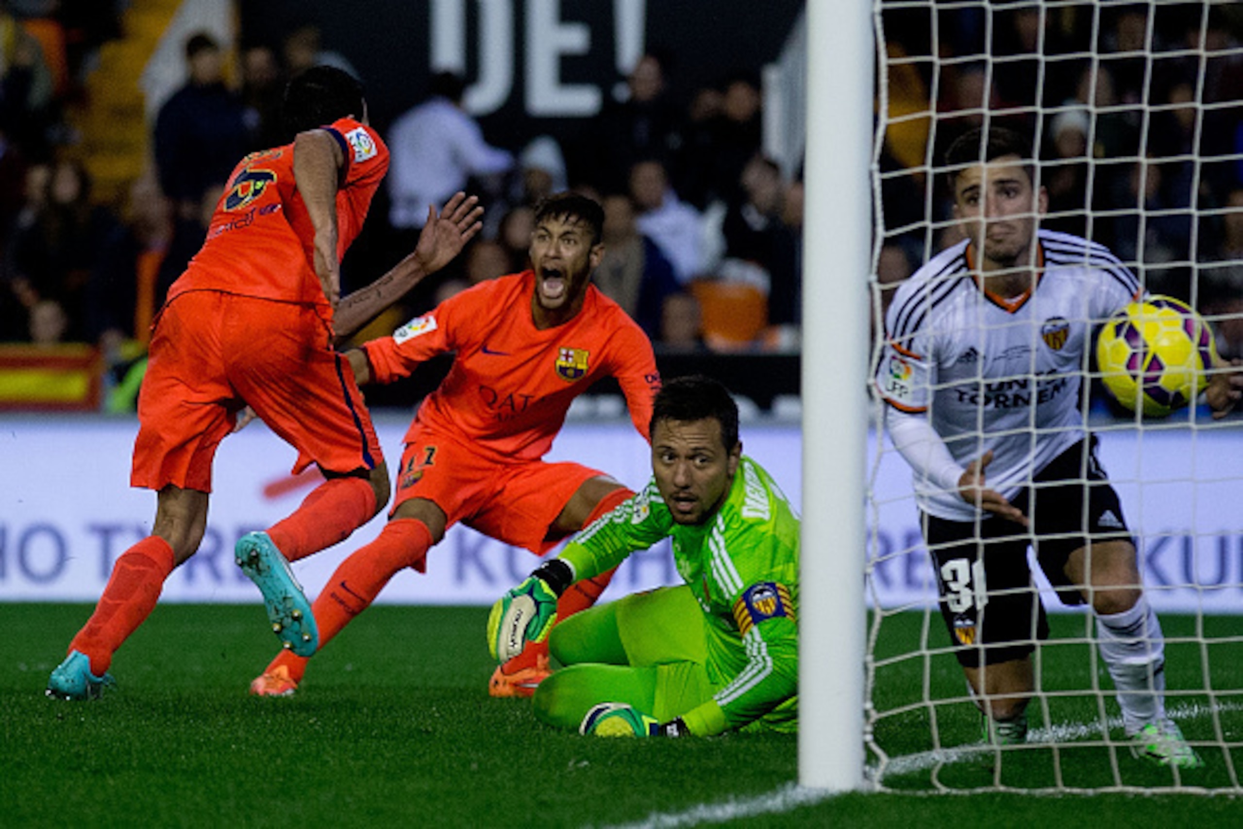 VALENCIA, SPAIN - NOVEMBER 30:  Sergio Busquets Burgos (L) of FC Barcelona celebrates his opening goal with team mate Neymar JR. (2ndL) as goalkeeper Diego Alves (2ndR) lies on the ground close to his teammate Jose Gaya (R) during the La Liga match betwee