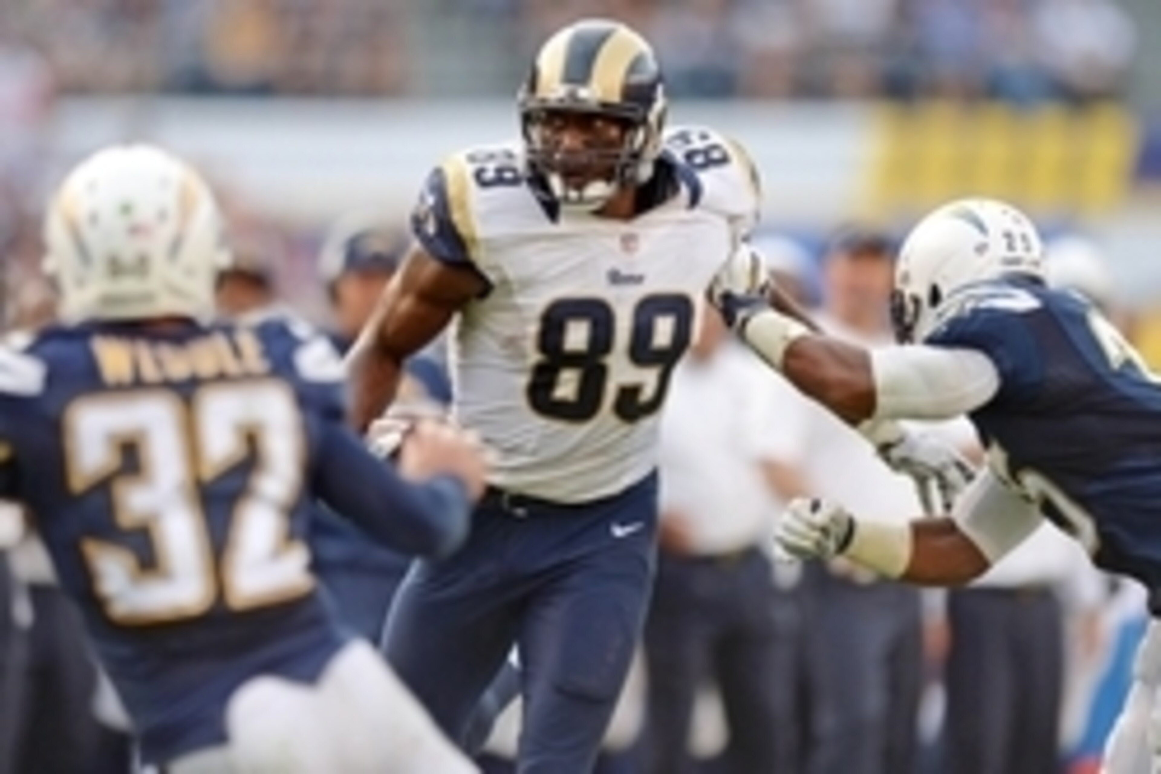 Nov 23, 2014; San Diego, CA, USA; St. Louis Rams tight end Jared Cook (89) is defended by San Diego Chargers free safety Eric Weddle (32) and defensive back Darrell Stuckey (25) during the fourth quarter at Qualcomm Stadium. Mandatory Credit: Jake Roth-US