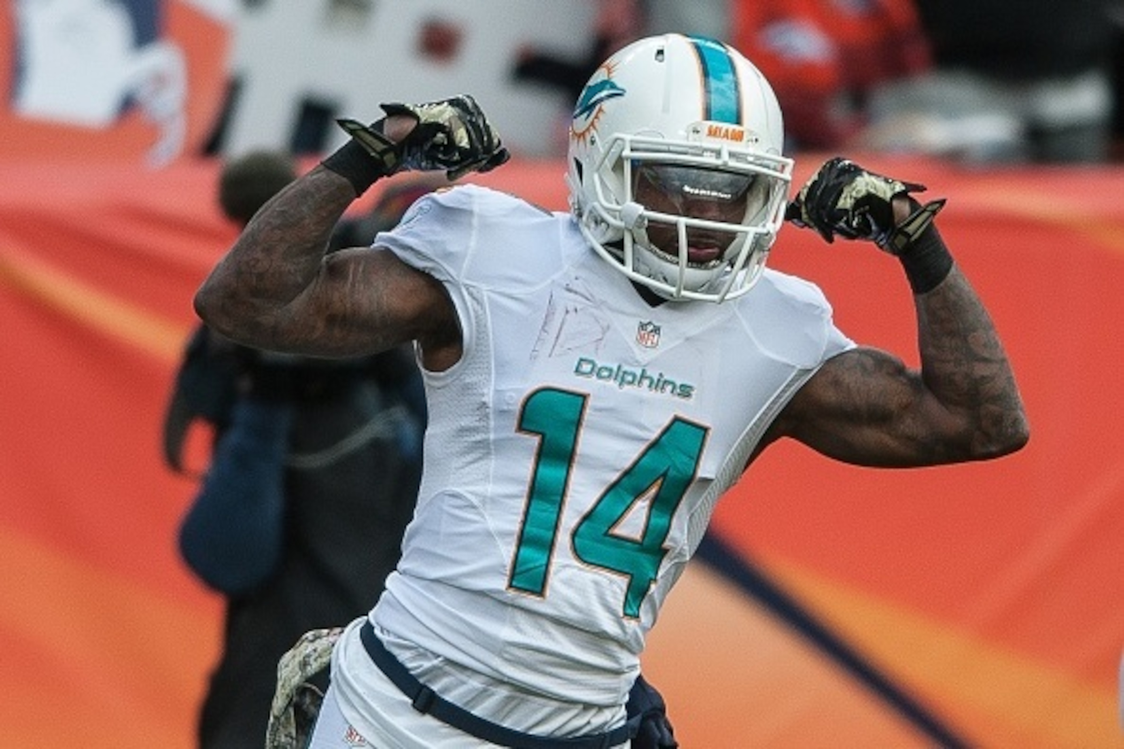 DENVER, CO - NOVEMBER 23:  Wide receiver Jarvis Landry #14 of the Miami Dolphins celebrates a 20-yard reception in the first quarter of a game against the Denver Broncos at Sports Authority Field at Mile High on November 23, 2014 in Denver, Colorado.  (Ph