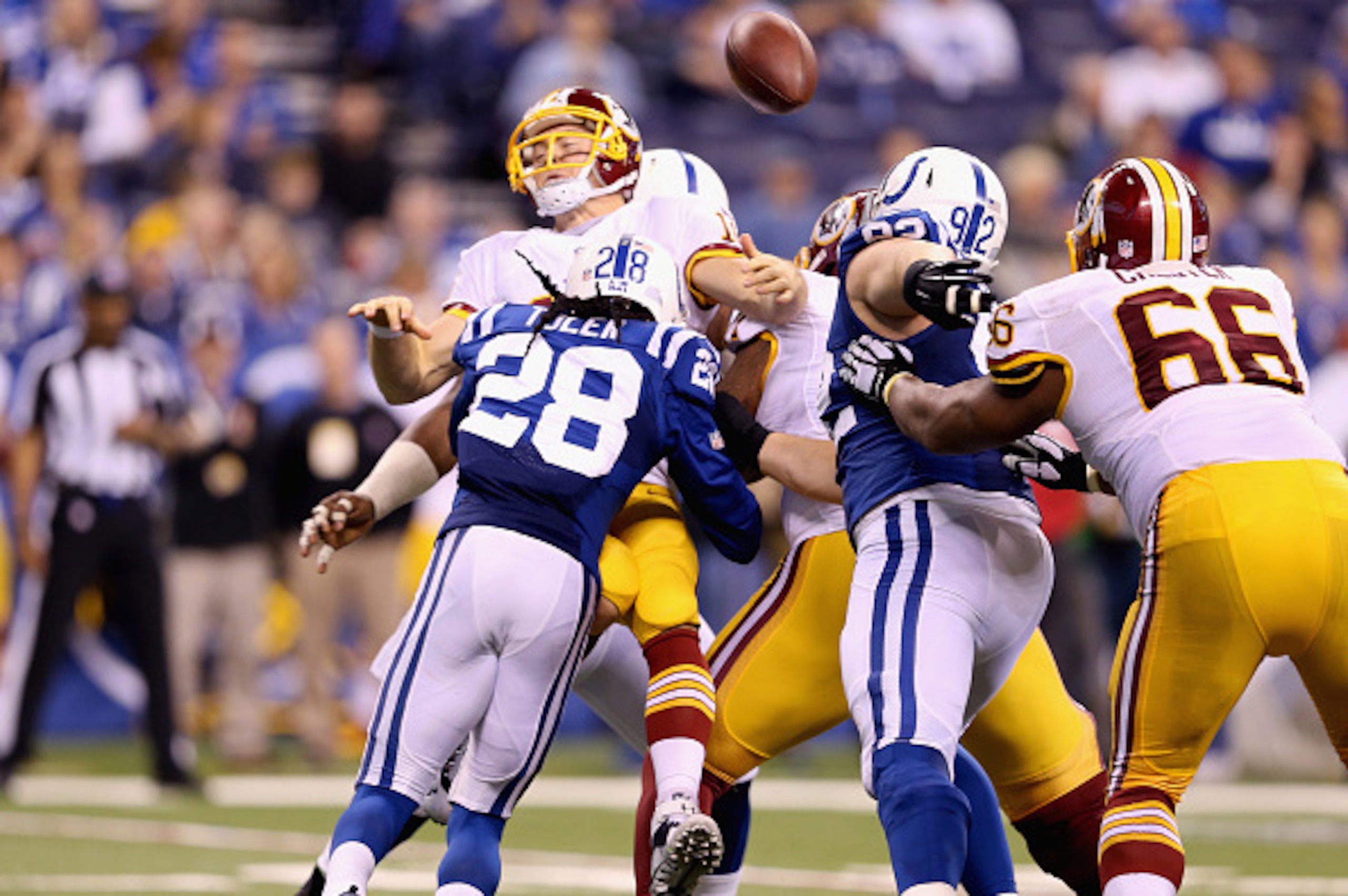 INDIANAPOLIS, IN - NOVEMBER 30:  Colt McCoy #16 of the Washington Redskins fumbles the ball after getting sacked during the game against the Indianapolis Colts at Lucas Oil Stadium on November 30, 2014 in Indianapolis, Indiana.  (Photo by Andy Lyons/Getty