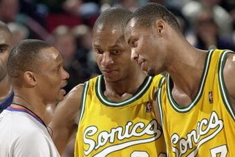 SEATTLE - JANUARY 27:  Ray Allen #34 and Rashard Lewis #7 of the Seattle Sonics talks with referee Michael Smith during the game against the Dallas Mavericks on January 27, 2004 at Key Arena in Seattle, Washington.  The Mavericks won 118-116.  NOTE TO USE