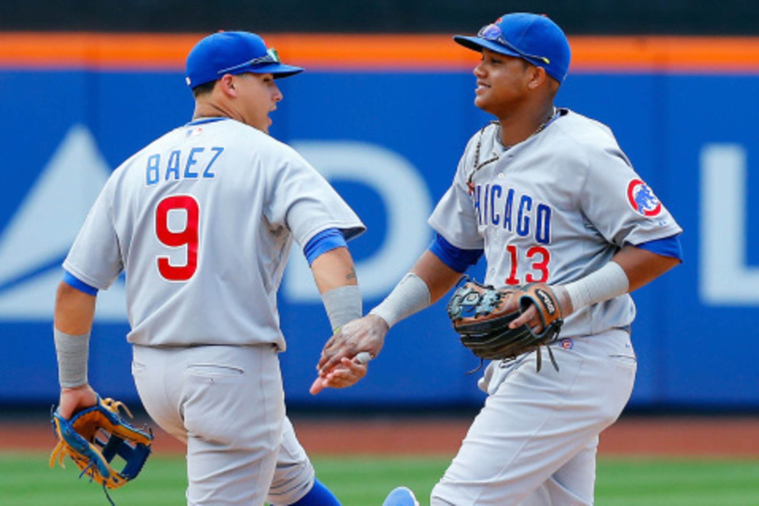 NEW YORK, NY - AUGUST 17: Starlin Castro #13 and Javier Baez #9 of the Chicago Cubs celebrate after defeating the New York Mets at Citi Field on August 17, 2014 in the Flushing neighborhood of the Queens borough of New York City. (Photo by Jim McIsaac/Get
