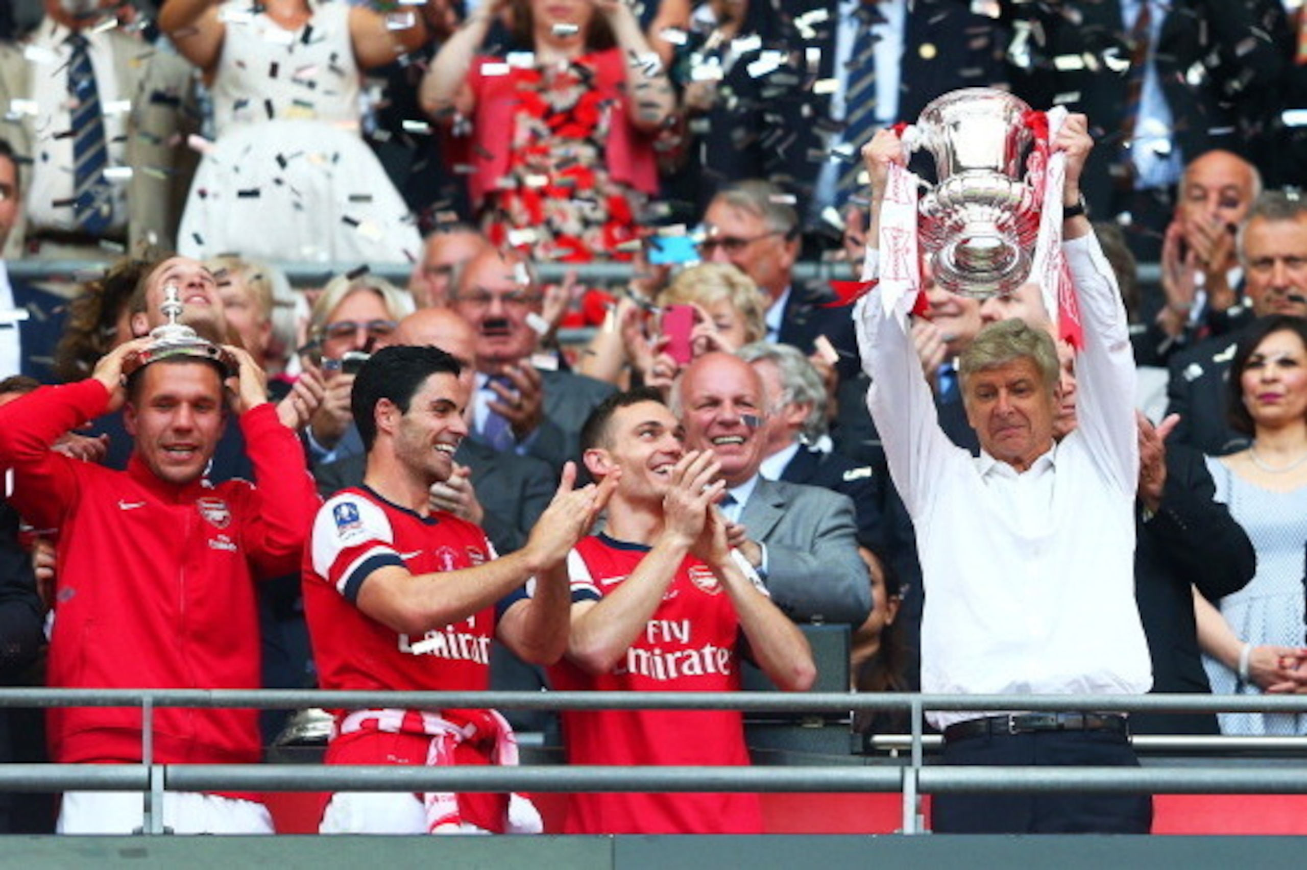 LONDON, ENGLAND - MAY 17:  Arsene Wenger manager of Arsenal (R) lifts the trophy in celebration alongside Lukas Podolski (L), Mikel Arteta (2L) and Thomas Vermaelen (2R) after the FA Cup with Budweiser Final match between Arsenal and Hull City at Wembley 