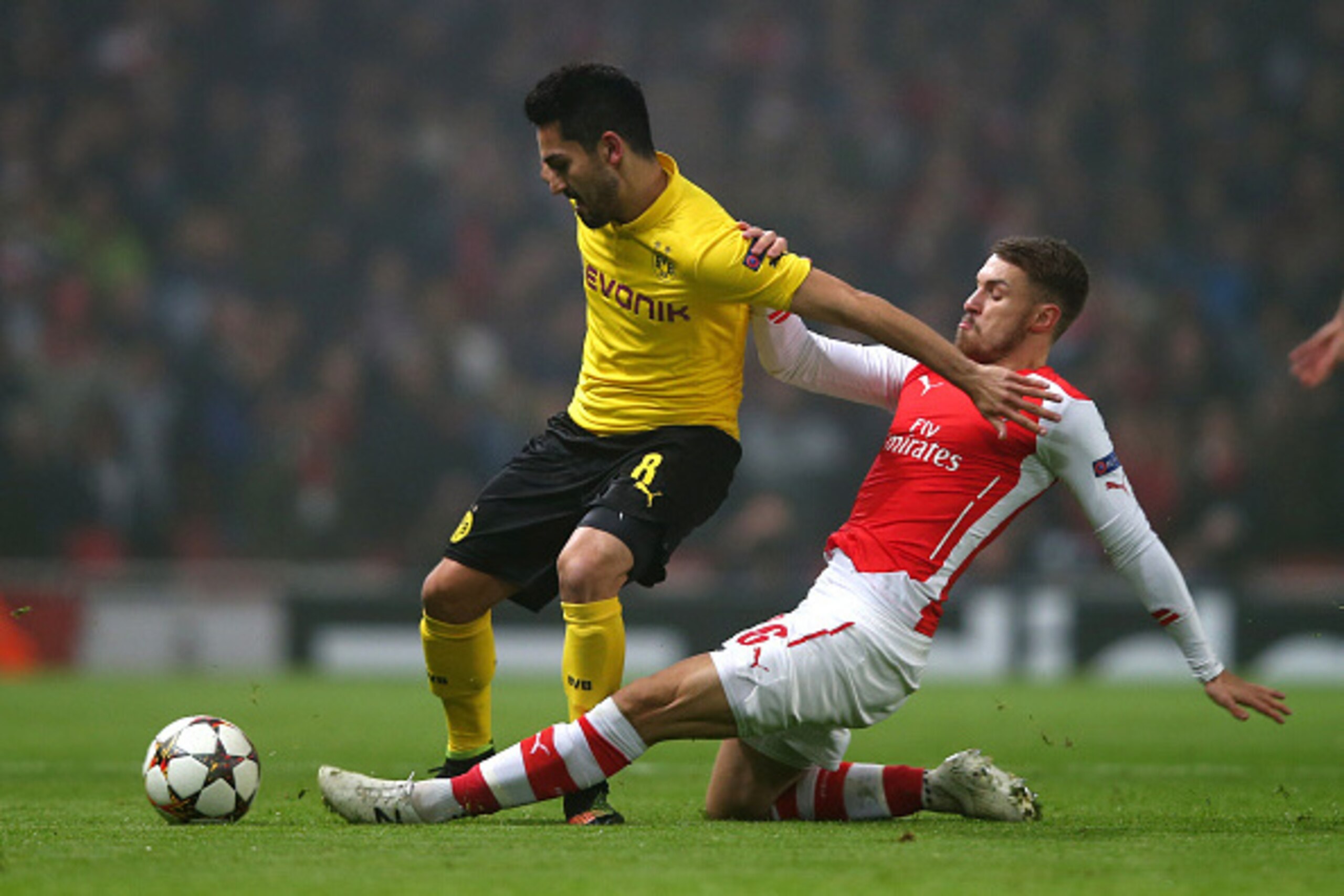 LONDON, ENGLAND - NOVEMBER 26:  Ilkay Gundogan of Borussia Dortmund is tackled by Aaron Ramsey of Arsenal during the UEFA Champions League Group D match between Arsenal and Borussia Dortmund at the Emirates Stadium on November 26, 2014 in London, United K