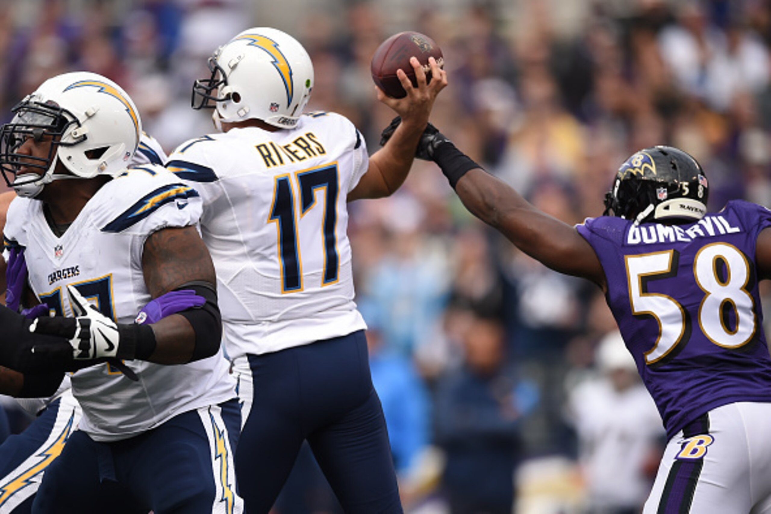 BALTIMORE, MD - NOVEMBER 30: Outside linebacker Elvis Dumervil #58 of the Baltimore Ravens tries to block a pass thrown by quarterback Philip Rivers #17 of the San Diego Chargers in the first half at M&T Bank Stadium on November 30, 2014 in Baltimore, Mar