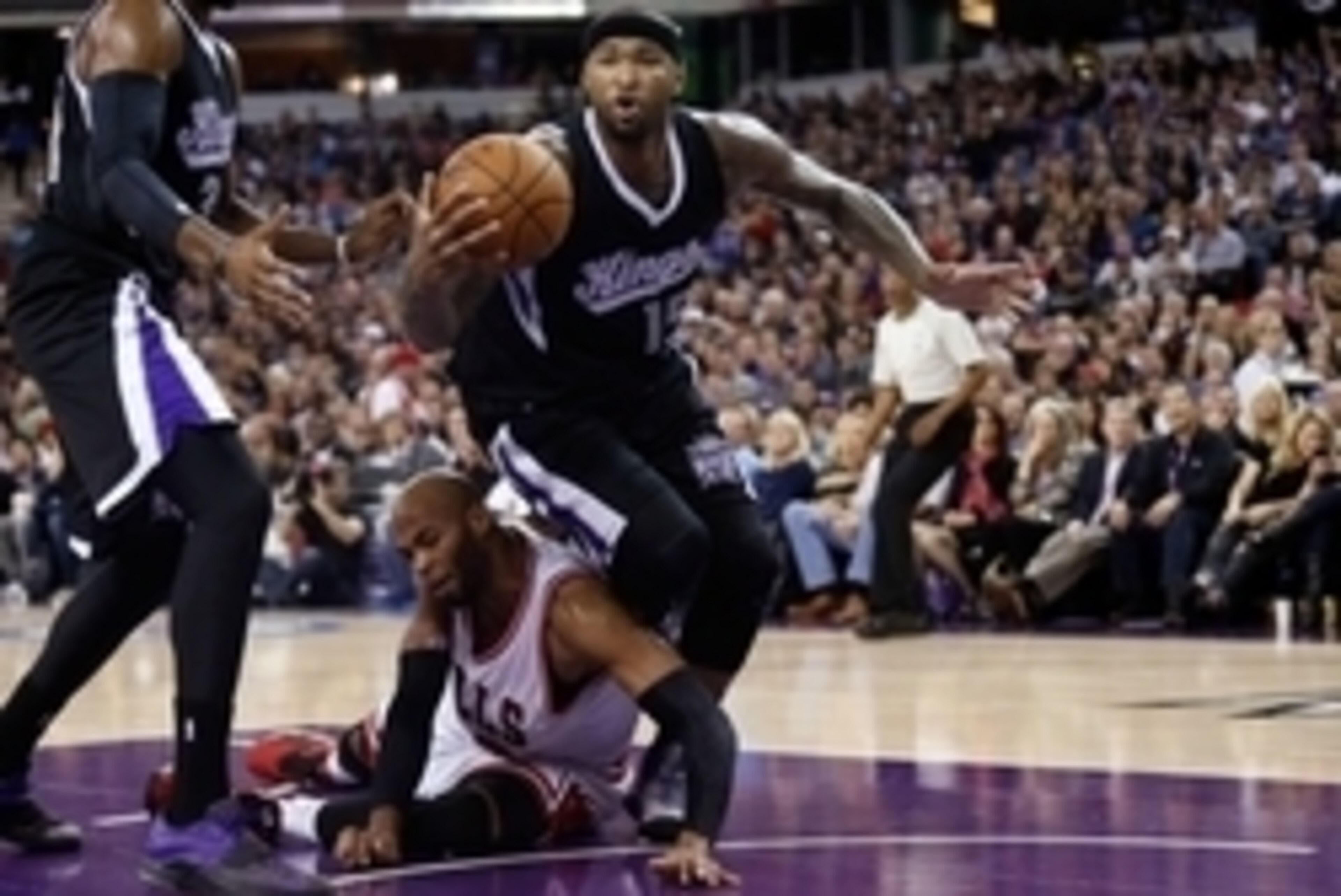 Nov 20, 2014; Sacramento, CA, USA; Chicago Bulls forward Taj Gibson (22) fouls Sacramento Kings center DeMarcus Cousins (15) from the floor during the third quarter at Sleep Train Arena. The Sacramento Kings defeated the Chicago Bulls 103-88. Mandatory Cr