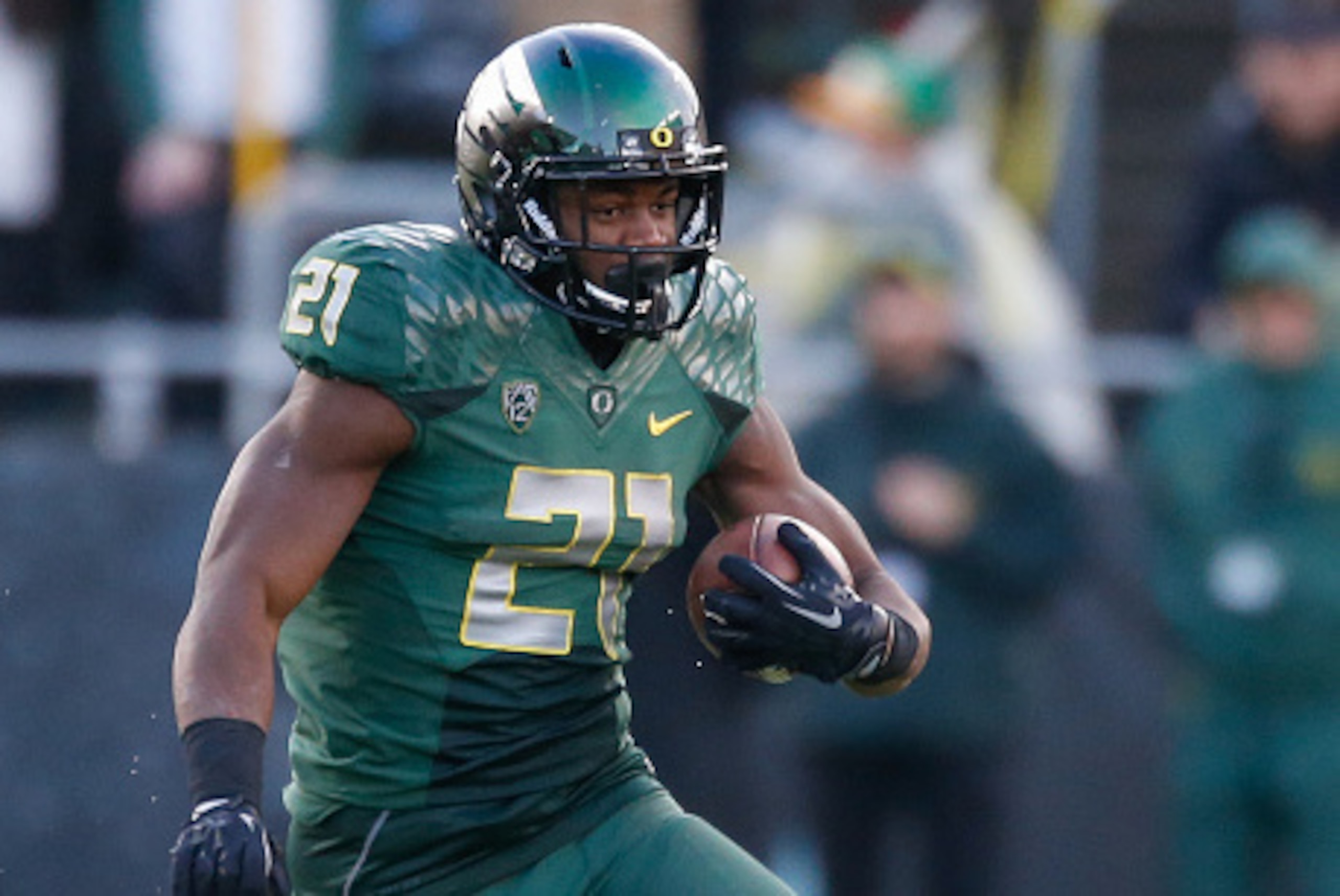 EUGENE, OR - NOVEMBER 22:  Running back Royce Freeman #21 of the Oregon Ducks rushes against the Colorado Buffaloes at Autzen Stadium on November 22, 2014 in Eugene, Oregon.  (Photo by Otto Greule Jr/Getty Images)