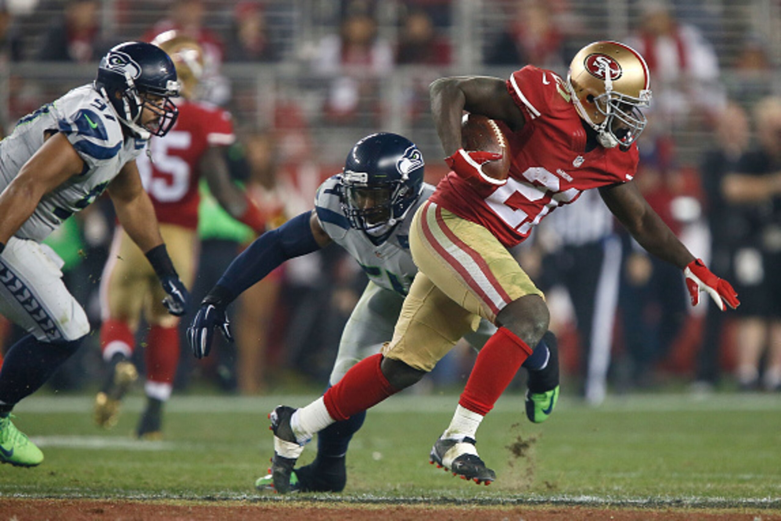 SANTA CLARA, CA - NOVEMBER 27:  Frank Gore #21 of the San Francisco 49ers beats the tackle from Bobby Wagner #54 of the Seattle Seahawks in the second half  at Levi's Stadium on November 27, 2014 in Santa Clara, California.  (Photo by Brian Bahr/Getty Ima