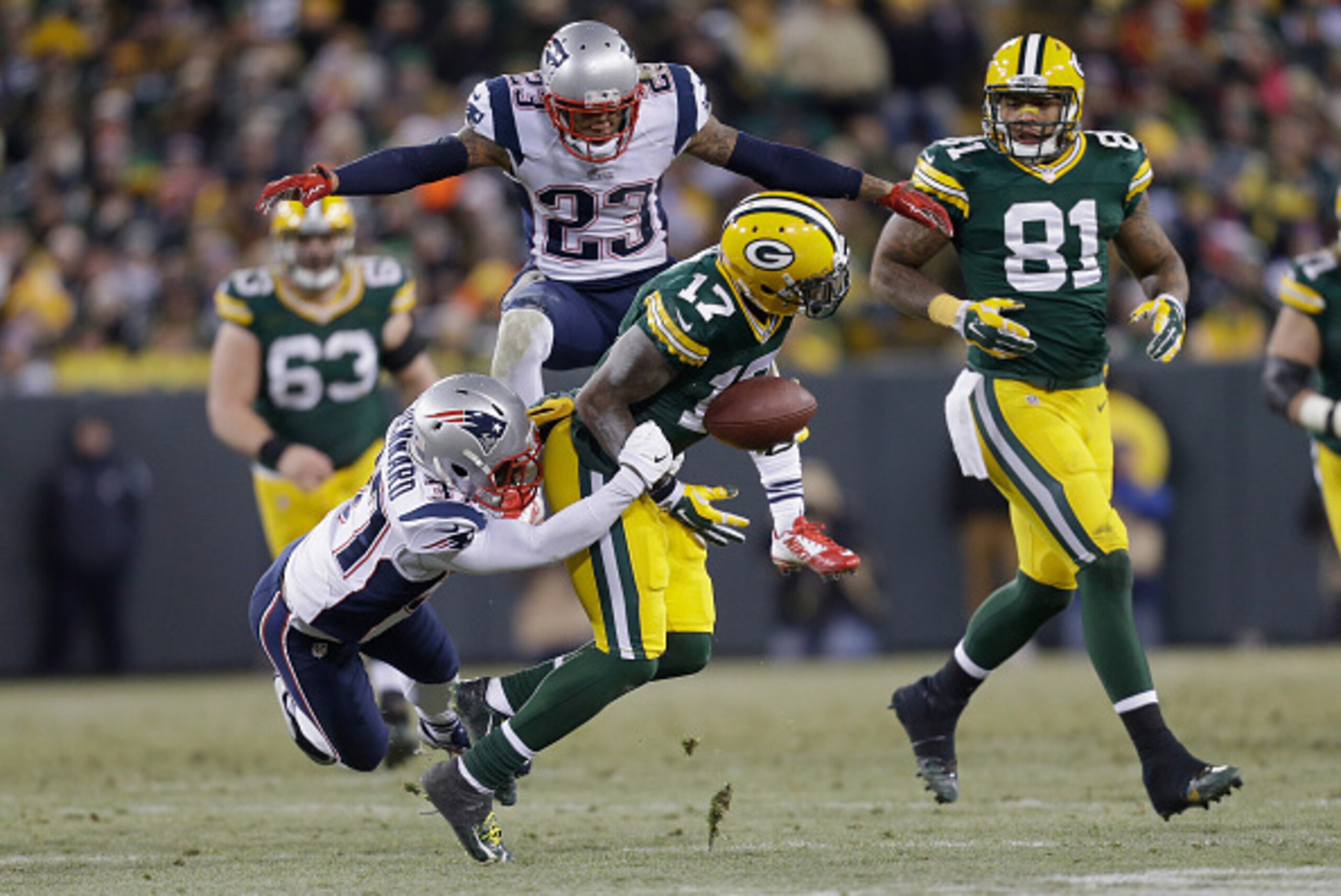 GREEN BAY, WI - NOVEMBER 30:  Strong safety Tavon Wilson #27 of the New England Patriots grabs wide receiver Davante Adams #17 of the Green Bay Packers as strong safety Patrick Chung #23 jumps behind, in the first half of the NFL game at Lambeau Field on 