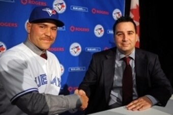 Nov 20, 2014; Toronto, Ontario, CAN;  Toronto Blue Jays catcher Russell Martin (left) shakes hands with general manager Alex Anthopoulos after Martin was introduced at a press conference at Rogers Centre. Mandatory Credit: Dan Hamilton-USA TODAY Sports