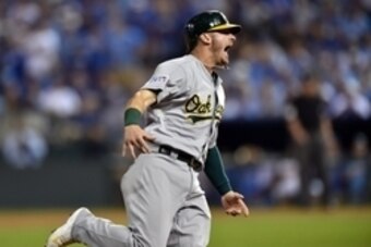Sep 30, 2014; Kansas City, MO, USA; Oakland Athletics third baseman Josh Donaldson (20) reacts as he round third base on the three-run home run by designated hitter Brandon Moss (37) against the Kansas City Royals during the sixth inning of the 2014 Ameri